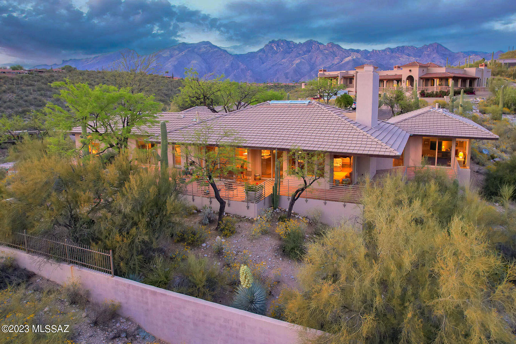 Views! Views! Views! An architecturally unique 
contemporary home situated on an elevated 1.9+ acre lot in River Heights Estates. The unparalleled panoramic views of the city, mountains, sunrise & sunset are breathtaking.  Floor to ceiling windows, throughout the house, capture the magnificent setting bringing the outside in. The inviting courtyard entry has lush landscaping & exquisite floral gardens. The multiple patios & decks are perfect for enjoying Tucson's outdoor lifestyle. The high vaulted ceilings, w/exposed beams, accentuate the open floor plan. The great room includes a fireplace, a gracious dining area & is open to the kitchen. The kitchen, defined by wrap around counters, has a large island, custom designed natural oak cabinets, a breakfast nook &  lots of storage. Expansive windows & built-ins describe the den, ideal for reading or watching TV. The primary bedroom suite includes a walk-in closet & luxurious bathroom w/a built-in dressing table, dual vanities & a large shower. In addition to the 3 bedrooms & the den, the design includes an office complete w/built-in bookcases. All of the bedrooms have ensuite bathrooms & access the patio/deck area.  The laundry room includes washer, dryer, sink & has great storage. Attached to the 2 car garage is a huge storage room. Roof was replaced by Castle Roofing in 2018. The 3 HVAC units were replaced in 2017. Original owner. Convenient to shopping and restaurants. A very special property. View now.