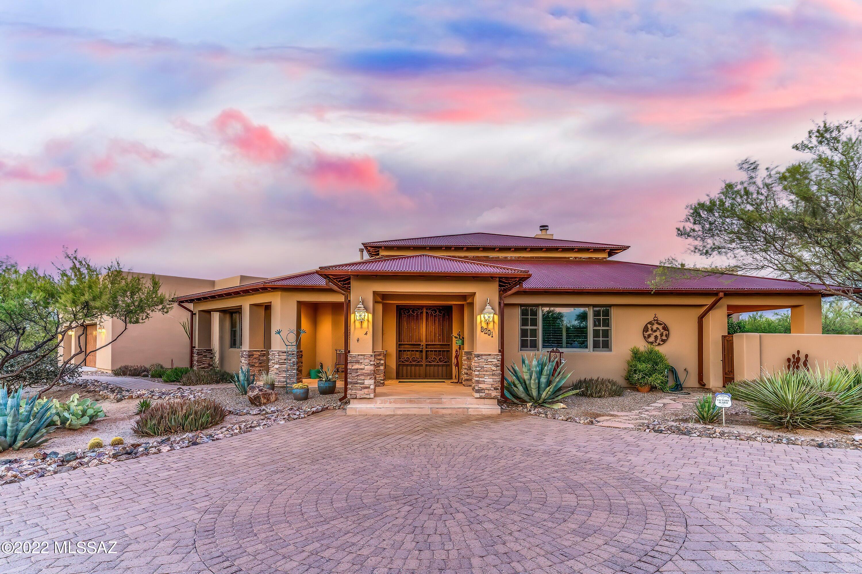 Rustic Elegance in Coyote Creek with splendid views of the Rincon Mountains,  Situated on 1.3 acres...No expense has been spared, 3,575 square feet, 4 br. or 3 br.  plus an office/library with beautiful  built-ins.  3-1/2 bath, 2 master suites one at each end of the house. Fabulous kitchen a ''chefs paradise.'' huge center granite island with  sink,  High end appliances.  Colored built up epoxy flooring and carpet.  Beamed ceilings, Alder doors and cabinets through-out, formal dining,. Great Room features 16'X10' sliding glass pocket doors, 2 fireplaces, 1 in the great room and 1 outside patio. Outside patio opens up to a beautifully landscaped garden with outside kitchen. Gardeners Delight! Oversized 3 car garage with workshop and additional storage.Bull Frog hot tub located on side patio