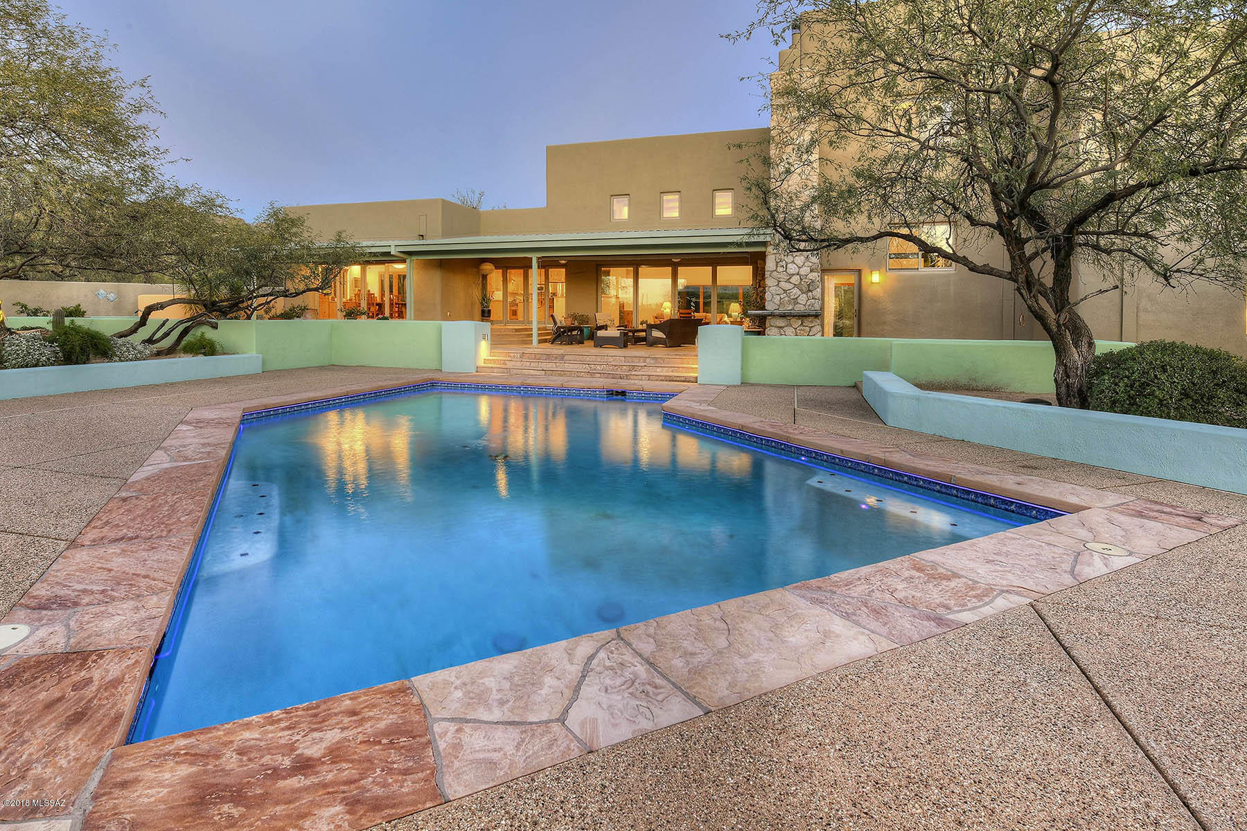 The entire home was custom designed to capture breathtaking 360 degree mountain views.  As you walk in the foyer, the aviation inspired plumbed fountain starts your journey into this captivating home. This 4 bedroom, 3 bath main home has a pool house/game room + full bath overlooking the saltwater pool. The 2nd floor spacious master suite features a large private patio & cozy sitting area w/fireplace. 3rd floor quiet reading/yoga room with deck able to support a hot tub. Native stones were gathered from the 3.49ac to comprise the centerpiece and heart of the living area creating a natural union of the home and the desert surroundings. 2,134 sqft 5 car garage attached to the bonus room w/ full bath. Horse facilities with water & electric & easy access to trails. Tanque Verde School Dist