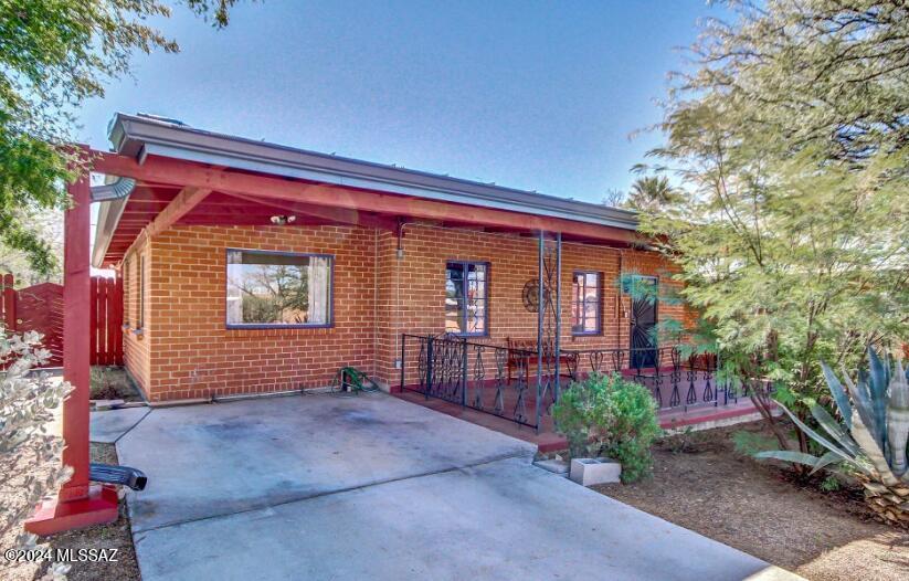 Beautiful Santa Fe-style home in Tucson's desirable Jefferson Park Addition. This single-story residence offers 1,643 sq. ft. of bright and inviting living space on a 0.17-acre lot. With 4 bedrooms and 2 full baths, the home features an open, airy layout accentuated by a stunning wood-beamed ceiling with oversized skylights, Saltillo tile, and custom wood trim throughout. The remodeled kitchen includes a breakfast bar with Mexican-tiled countertops, stainless steel appliances, and stylish wood cabinetry. The upgraded bathrooms boast designer tiles and fixtures. A cozy mother-in-law suite provides a private retreat with a fireplace, kitchenette, and mini-split AC, along with easy access to the patio. Other upgrades include AC and heating system improvements, new gutters.