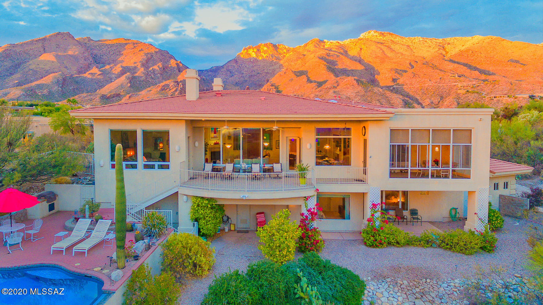 Enjoy the best golf course views in all of Tucson in this stunning contemporary 4bed/5bath home at end of cul-de-sac in the exclusive gated community of Ventana Entrada. Unobstructed city & mountain views overlooking the 12th green on the Canyon course. Enter through foyer w/ vaulted ceilings leading into great room w/ travertine flooring, abundance of natural light w/ oversized windows, FP, & kitchen featuring granite peninsula, custom cherry cabinets, SS appliances, & butler's pantry w/ electric dumbwaiter. Well designed split floor plan w/ elevator shaft ready for easy install. Spacious master suite w/ access to deck, dual closets, & double vanity. En suite guest rooms on lower level w/ walkout to resort-like back yard w/ negative edge pool, spa, & built-in BBQ.