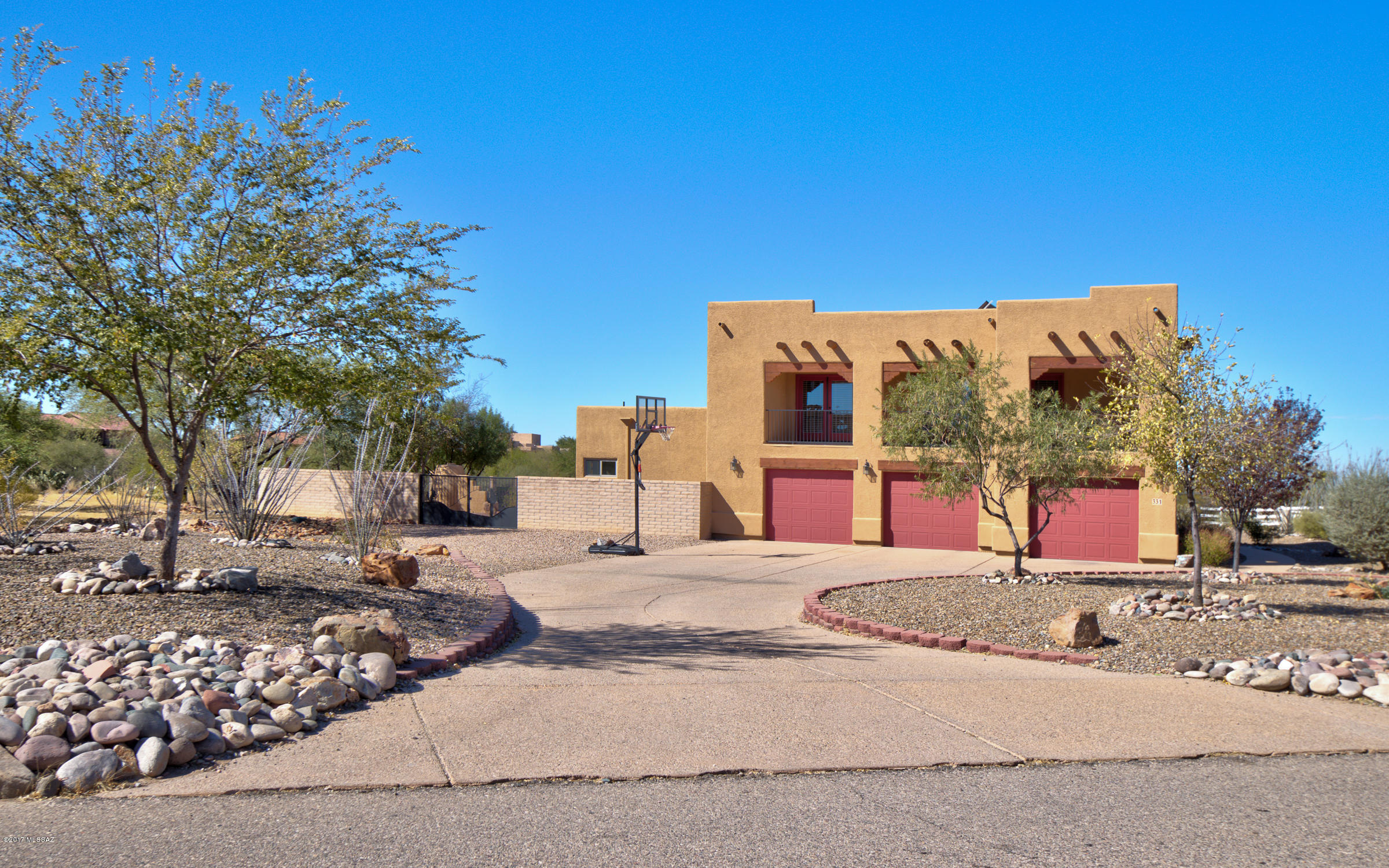 Gorgeous Two-Story Santa Fe Style Home with 3 bedrooms, 3 ½ baths, loft, den, 3,455 SqFt, extended 3-car garage located in sunny Vail, Arizona on Horse Property! Greeted by a circular driveway and gorgeous mountain views! Many custom touches throughout. Open concept kitchen to dining area and great room w/fireplace. Kitchen boasts limestone and granite counter tops, double sink, stainless appliances, freezer, and walk-in pantry. Popular split bedroom plan. Retreat to the Master Bedroom with en suite bath w/ dual sink vanity, jetted tub, separate shower and walk in closet. Roomy loft upstairs great for games or playroom, French doors open to the covered balcony. Reverse osmosis water system. Backyard oasis has it all!