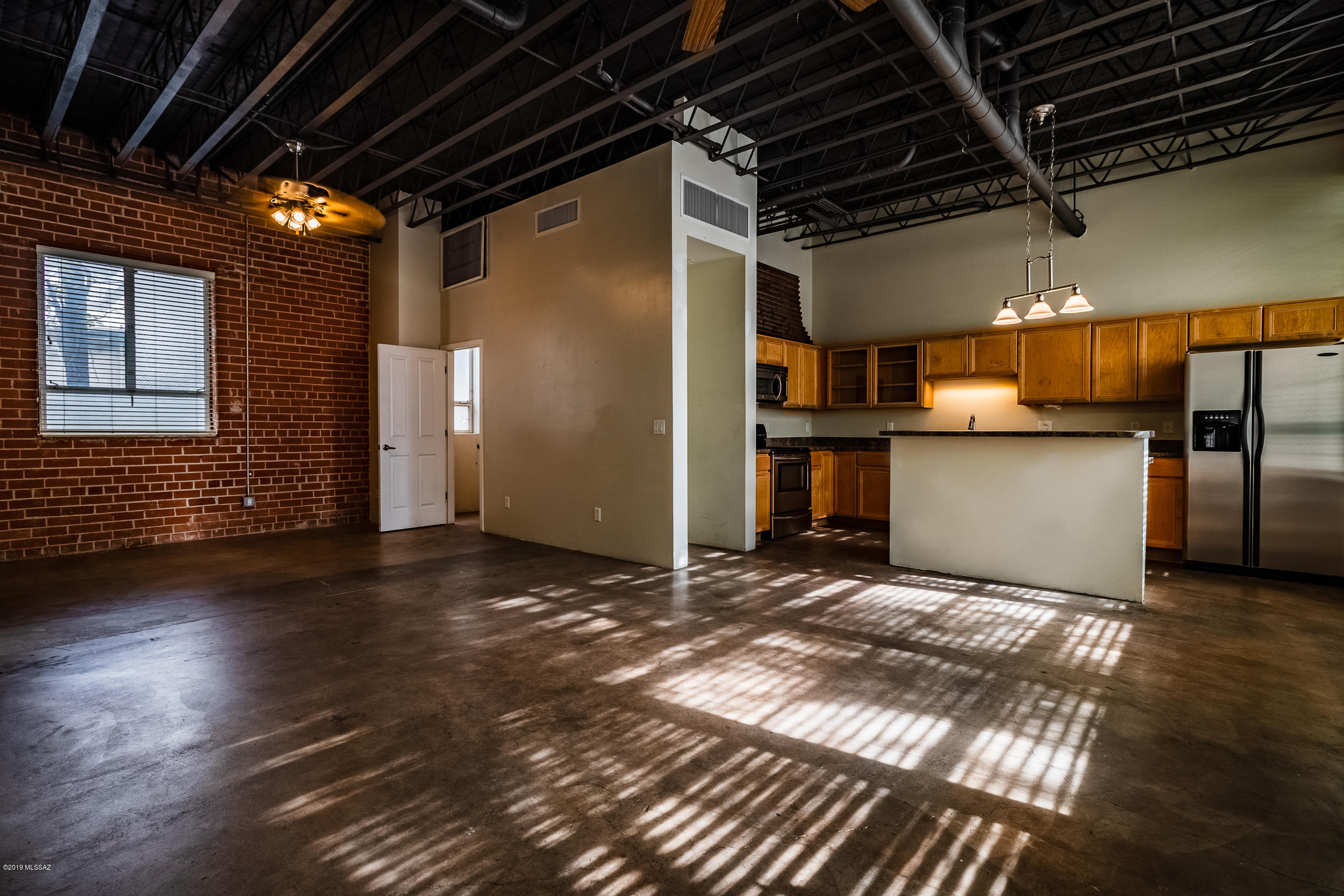 The Academy Lofts, located in Armory Park and offers a property with classic historic architecture and modern features with open floor space surrounded by exposed brick, concrete and steel trusses. Bright, light and open; this Loft has a creative open interior, stylish kitchen and bath. soaring ceilings, concrete floors, tall windows, Ceiling fans, large Walk in closet and Washer/dryer hook up. This  gated property offers covered parking and a convenient location to downtown Tucson, just about 3 blocks away.  Leave the car and Enjoy an urban lifestyle right outside your door: streetcar, buses, the loop, restaurants, theater, concerts, groceries, urgent care, Mercado, MSA Annex, craft bars, museums, art, history, culture, arcades, nightclubs, hotels, 4th Ave shopping dis
