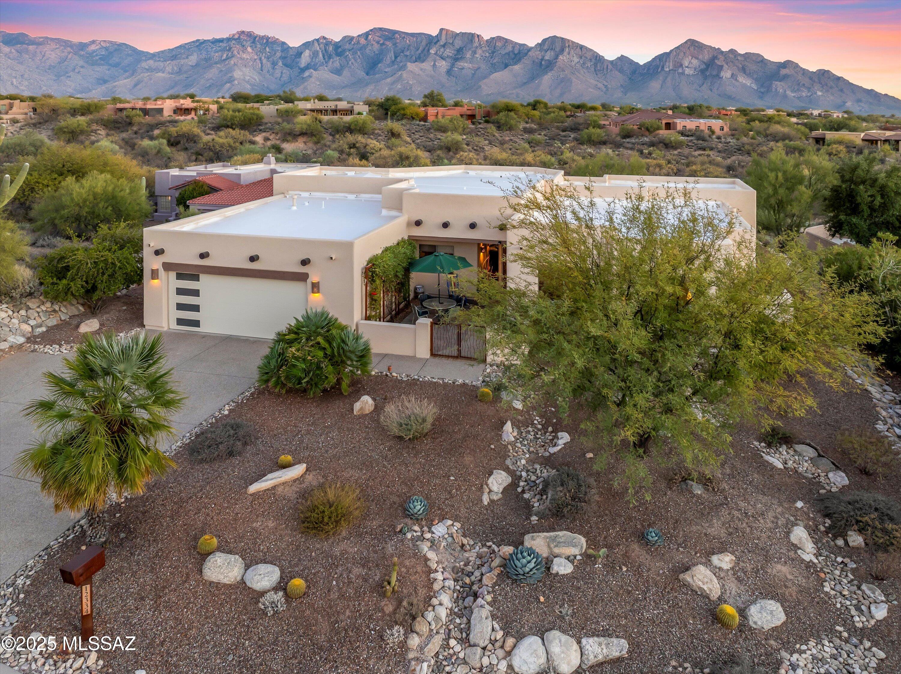 Welcome to your dream home. This 4-bedroom, 3-bathroom custom home offering 2,578 sq. ft. of thoughtfully designed living space on a generous 0.65-acre lot is nestled in a serene setting of natural desert and panoramic mountain views. This home boasts an open floor plan designed for modern living and entertaining. Step inside to discover an inviting interior with high ceilings, abundant natural light, and seamless flow between the living, dining, and kitchen areas. The spacious den/office provides the ideal space for working from home or a cozy retreat.  The primary suite has easy access to the back patio with stunning views right from bed, an en-suite bath and large custom walk-through closet (formerly bedroom #5).  READ MORE...... Three additional bedrooms provide comfort and flexibility for family guests or hobbies. Step outside to enjoy peace and tranquility with breathtaking mountain views and stunning sunsets from your expansive patio with a built in BBQ. An outdoor fireplace and a clever wrought iron open cage to feed the birds but not the wildlife, with its perfect blend of elegance, functionality, and location, this home is a must-see for anyone seeking comfort, privacy, and natural beauty.  Two newer HVAC units with smart thermostats (six years old), two newer water heaters (two years old), new exterior paint (end of 2024), Roof re-coated (end of 2024) Newly enclosed courtyard in front, reverse osmosis in the kitchen.
