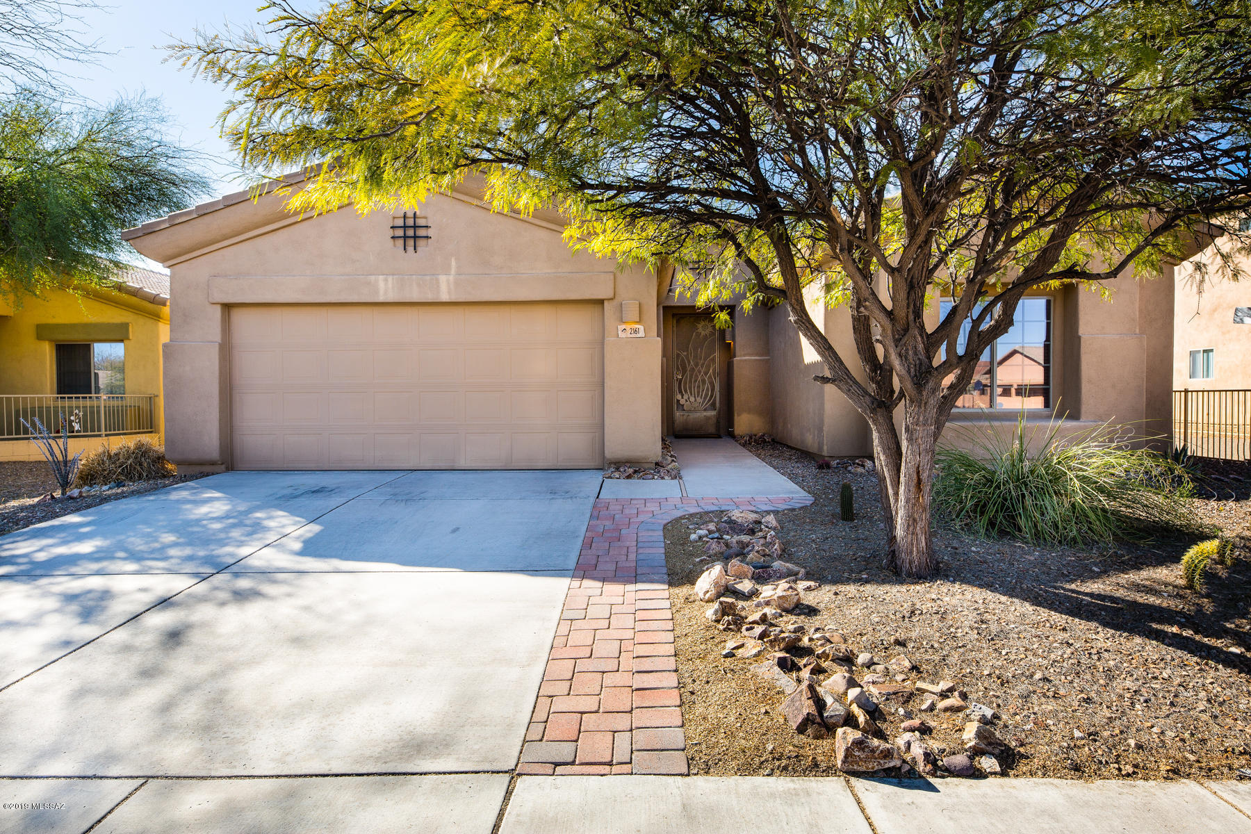 Move in ready single story, extended 2 car garage home with upgraded tile flooring, fresh paint, and landscaped backyard. Home entrance features a beautiful wrought iron security door that leads to an open family room and kitchen layout. Windows have newly added blinds that allow for natural light to fill dining and living area. Kitchen has a deep pantry and breakfast bar. Split floor plan with two full bathrooms and three bedrooms. Master Suite is spacious with walk in closet and long bathroom vanity. Backyard features artificial grass and full patio deck with pavers extension for larger sitting area to enjoy the desert sunsets. No rear neighbors. Neighborhood includes community pool with hot tub and grill area. Park has new playground equipment. Within walking distance to shopping area.