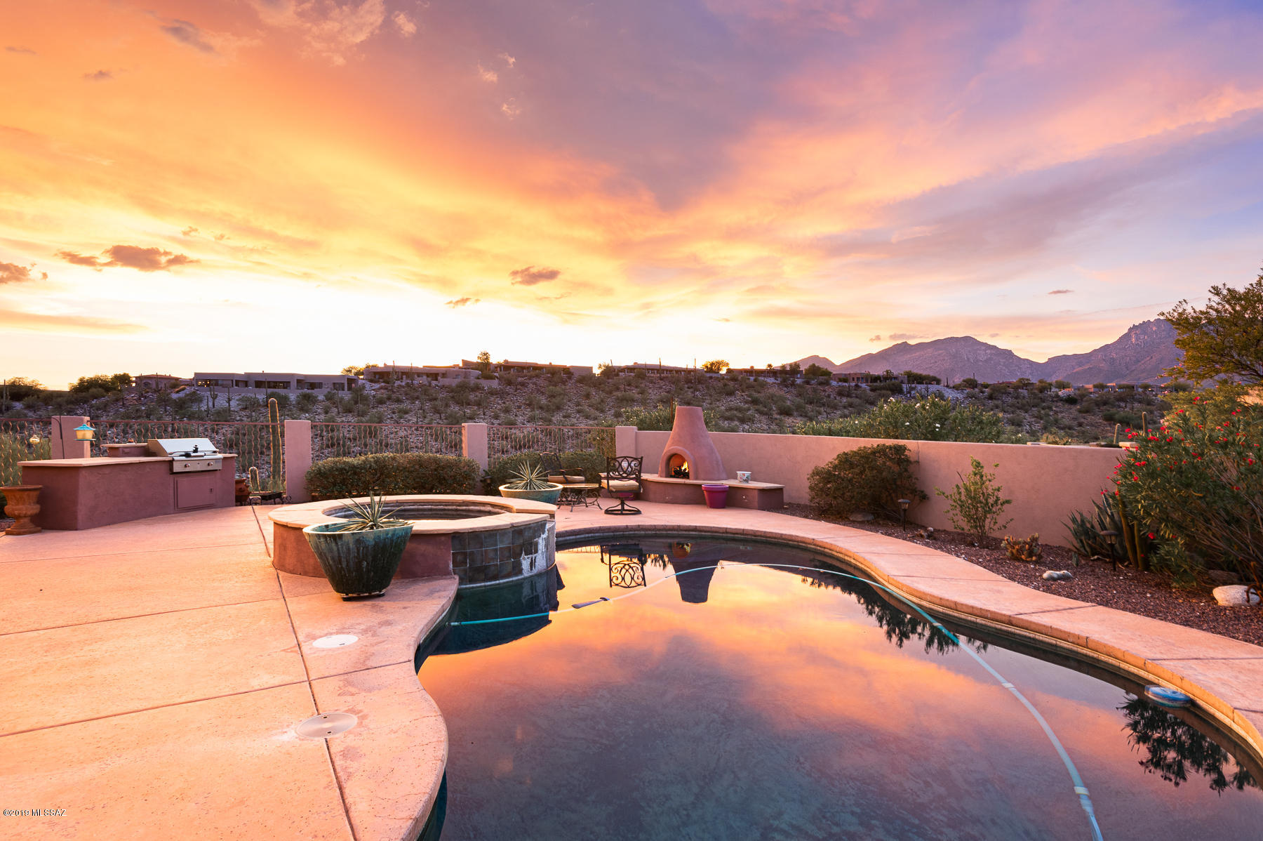 Stunning Spacious  Home Built in 2003 Situated on a Ridge Top lot in Gated Sabino Mountain.  Enjoy City, Mountain and Sunset Views.  Enter through a Charming Courtyard.  Wonderful Kitchen  has a Breakfast Bar and is open to the Family Rm with FP and Informal Dining - Views! Views!  Spacious Master Suite and Master Bathroom. There is also a separate Living Rm with FP and Formal Dining.  Beautiful Pool area with Spa, FP and BBQ overlooking the City and Mountains.  Oversized 3 car Gar, large laundry rm.  4th Bdrm used as Office. Incredible location minutes from Canyon Ranch, Sabino Canyon, World-Class Golf Resorts, Restaurants and Shopping.