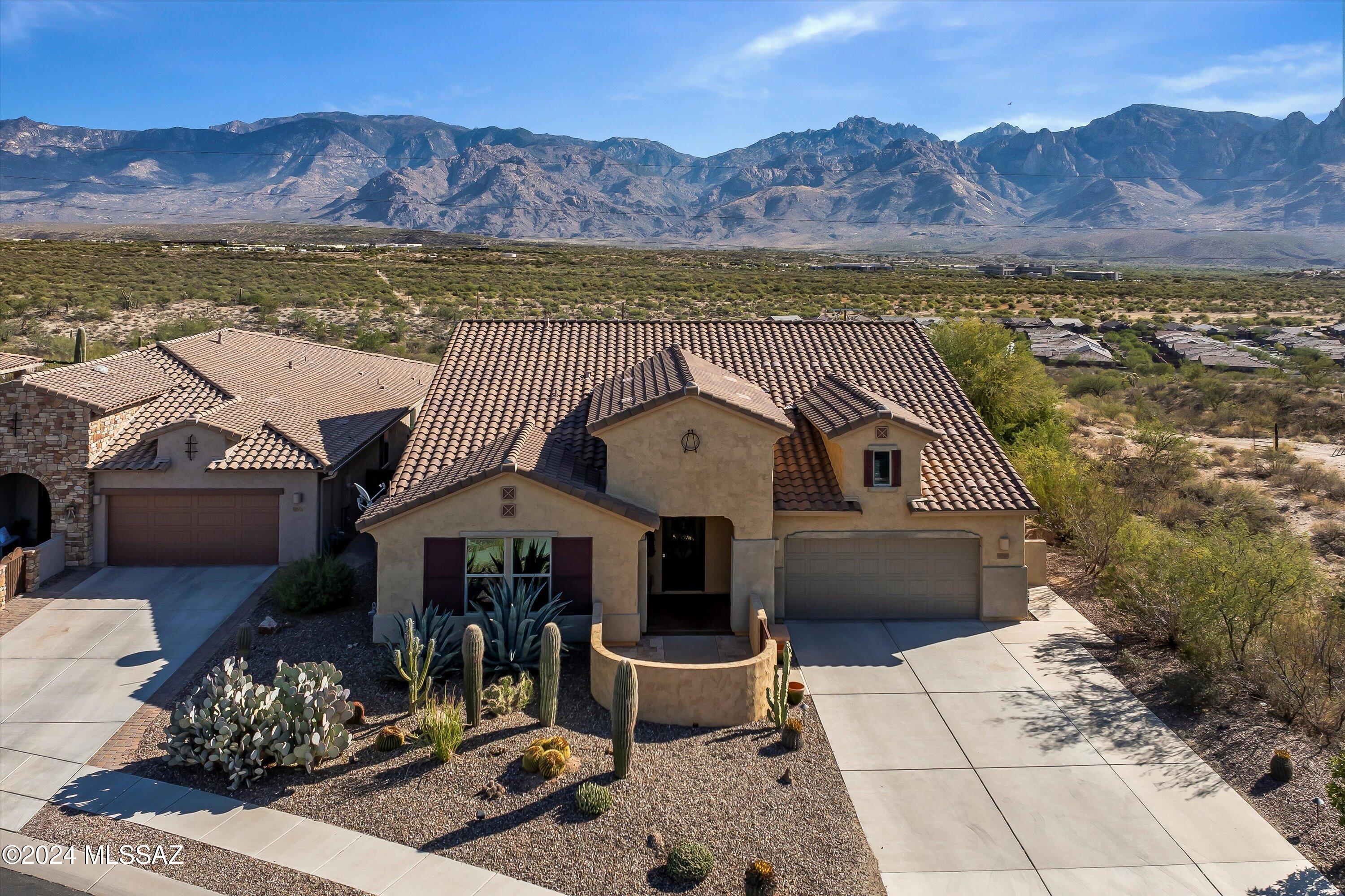 Experience serene living in this exquisite home nestled in the gated community of Hohokam Mesa. Perfectly positioned on a premium lot with breathtaking unobstructed views of the Catalina Mountains and backing to open space. With 4 BR's 3 BA's, & 3 car tandem garage, there's plenty of space for visiting family or creating a home office/hobby room. Kitchen is equipped w/elegant cabinets, granite countertops, SS appliances, double oven, gas cooktop, & Tuscan-inspired wine room, complete w/wine fridge. Spacious primary suite has custom walk-in closet, dual vanities & large walk-in shower. Outside, you'll find a built-in BBQ, custom pergola & stone gas fireplace, perfect for outdoor relaxation & entertaining. This home combines luxury, comfort, & stunning views in one exceptional package.