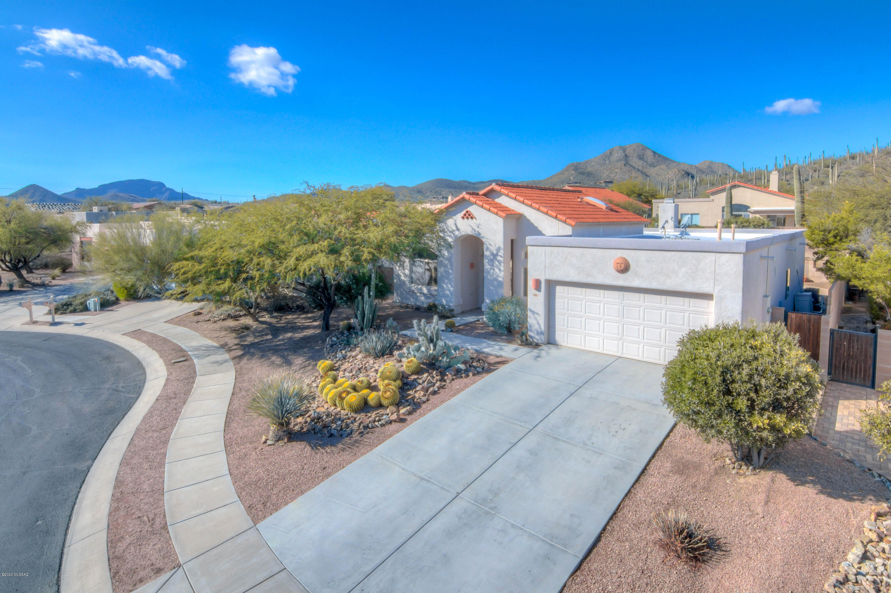 You must not miss this meticulously maintained 3BR/2BA home with large den, formal dining and great room concept off kitchen. This quiet gated community is directly across from the Starr Pass Community, Golf, and Resort. Minutes from downtown & University of Arizona. Custom upgrades include wood entry door, hardware & fixtures, tile throughout, plantation shutters, surround sound, Large Greatroom off kitchen, complete with cozy fireplace! Jetted tub in master bath, with huge walk-in closet. Heated pool and spa w/recently coated kool decking, and new heater. Built-in gas BBQ, fire pit, and covered patio make this backyard oasis your quiet and relaxing escape. This is a MUST SEE home that will not last. Come visit your new home today!