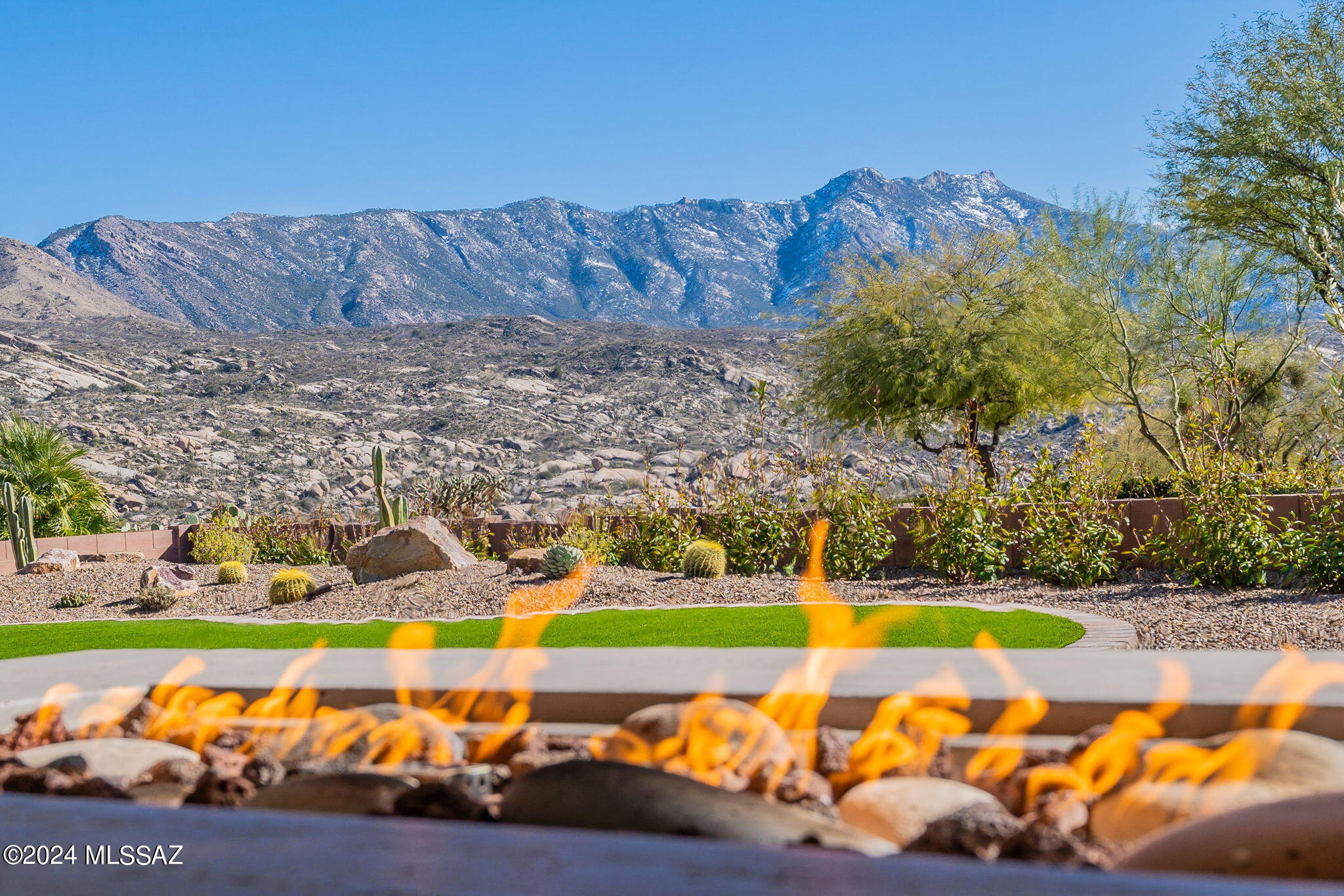 Stunning 2021 expanded SONRISA model with 3 bedroom suites plus den in The Preserve at SaddleBrooke. Corner lot provides mountain & golf course views. The living room wall of glass & dining room windows invite mtn views inside. Extensive upgrades - Wolf/Subzero appliances, quartz waterfall island, electric fireplace, app-controlled shades. Covered patio has portable fire table, eating area & motorized shades providing AZ room atmosphere. Primary suite includes walk-in shower and two closets w/plenty of drawers, rods and shelves. Added suite has fabulous mtn views for guests or dual primary suite. Over-sized corner lot offers sunsets from SW side & front courtyard. Garage storage nicely tucked behind doors. Whole house water treatment system. Sellers licensed to sell real estate in CA.