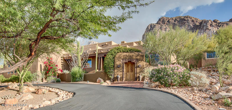 Luxury in a Natural Paradise!  Breathtaking Views! Mountain/City/ Sunset. FRESHLY PAINTED EXTERIOR, RECOATED RF.OVER $200,000/ upgrades/additions. Gorgeous Custom Home resting at the base of Pusch Ridge and bordering the Coronado National Forest! Features gated Courtyard, Gourmet kitchen, Remodeled Bathrooms, Triple Pane Windows, Solar Shades, Great room with Cozy Fireplace and built in Entertainment Center. Spare room with French doors that lead to office/den area. Huge Guest quarters/studio features power operated projection screen, balcony and its own sauna. Spacious master suite with his/her closets, jet tub and exit to the Private Backyard Oasis. Sparkling Pool, Spa, Outdoor Fireplace, Water feature and the absolutely Stunning Pusch Ridge Mountains. Perfect for Entertaining. Must see!