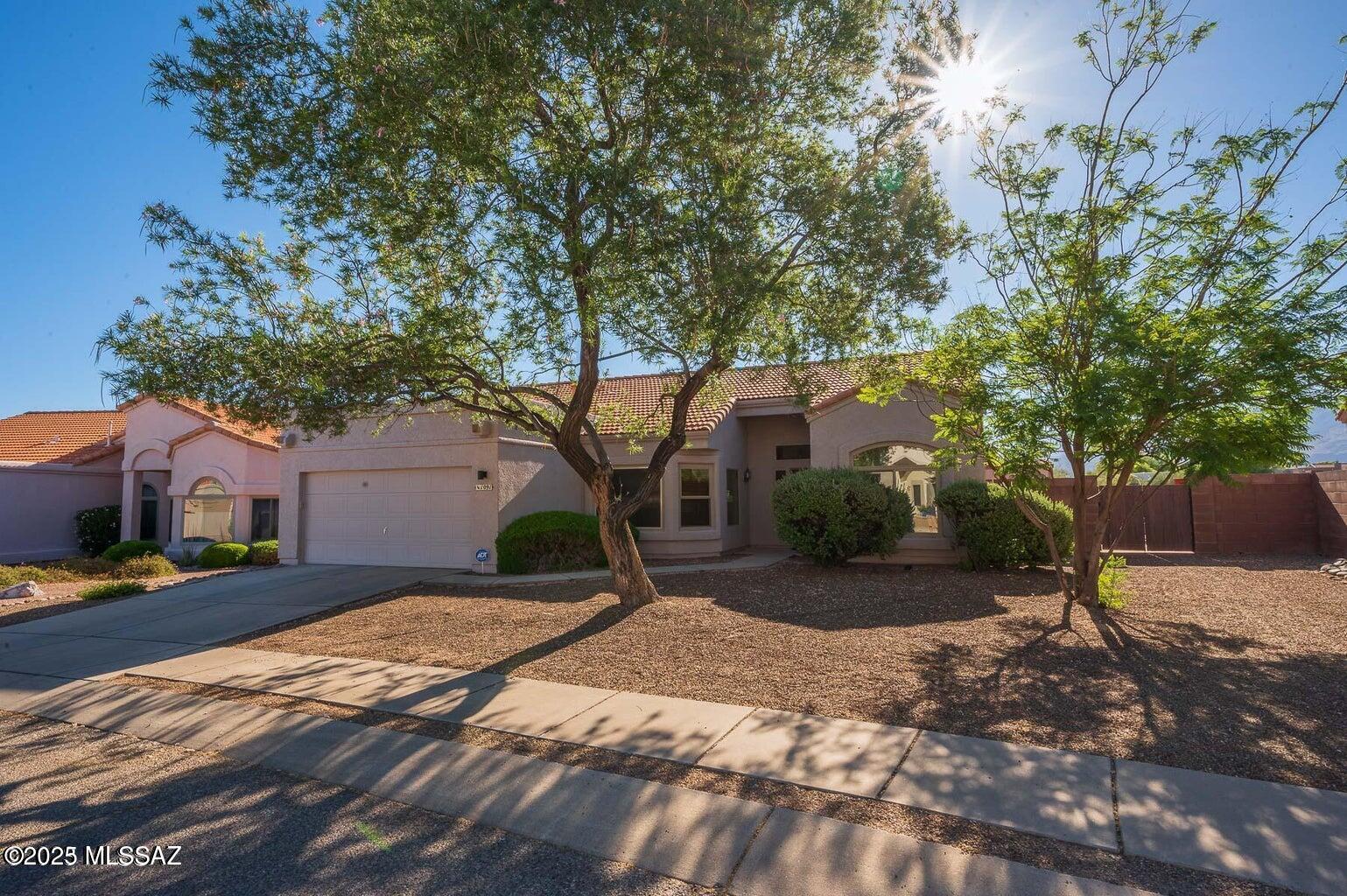 Spectacular Panoramic View of Rincon & Catalina Mountains. .44 acres!! Open and spacious, split floor plan! Completely updated! Envy of the neighborhood! HUGE back yard that backs to desert arroyo (that's right... no neighbors behind you). The back-yard retreat offers an endless entertaining vibe, to include tasteful landscape throughout, brick pavers, cement/concrete slabs, special seating arrangement for your guests. For the Golf Enthusiasts... your own Private Putting Green coupled with artificial grass... and a refreshing/relaxing in-ground pebble tec jacuzzi spa for those cozy cool nights of star-gazing! The side yard offers a large HOA approved wood workshop/work storage. The double gate access to your back yard is wide enough to roll a 4x6 utility trailer and/or your small RV toys! The inside... is tastefully updated and decorated with a HUGE Great Room, a wood burning fireplace, large Pella windows and large 8ft sliding glass door allow you to enjoy the beautiful Rincon Mountains. The home boasts vaulted ceilings and offers a large beautiful ceiling fan! The kitchen has been updated with new granite counters, stainless steel appliances, new window bay blinds in dining/nook area, skylight and new floor tile. The primary bathroom has been completely updated/renovated: new cabinet/top/fixture, new large format tile in shower/tub surround and new floor tile, and new shower/tub fixture system. This lovely and spacious home offers a split floor plan. The Master-Suite is HUGE and offers large Pella windows overlooking the Rincon Mountains and a large beautiful ceiling fan. The master bathroom has been completely updated/renovated with beautiful new 72" vanity cabinet with double sink and tasteful inlaid tile counter-top. You'll love all of the tasteful tile work throughout, to include in the large walk-in shower. Relax in your Mr Steam personal home steam/sauna room, which can also function as a secondary shower enclosure. The flooring was also recently updated with a beautiful diagonal tile layout. Large walk-in closet. Light & bright with lots of  large windows throughout. All windows in the house were updated with dual pane Pella Brand windows! In 2021 a new Pentair/Hayward filtration system was installed for the outdoor in-ground jacuzzi. The interior of home has been freshly painted with neutral color paint throughout. New 40gal gas hot water heater installed 2025. The HVAC unit is a TRANE and runs impeccably. The home offers a salt soft water system which works as it should, but is not currently being used. The home is clean, updated, turn-key and ready for new owners to enjoy! Calling all winter visitors.. it's move in ready to include furnishings if desired!! This is a very nice home with an amazing and entertaining back yard vibe! Oh and no homes behind you! The Silverado Hills Community is well sought after, established, quiet, well kept, private, neighborly and surrounded by lots of natural desert scenery and abundant wild life. Don't miss out on this one! Ready for immediate move-in and enjoyment.. The furnishings can convey if desired. One of the owners on deed is a licensed realtor.