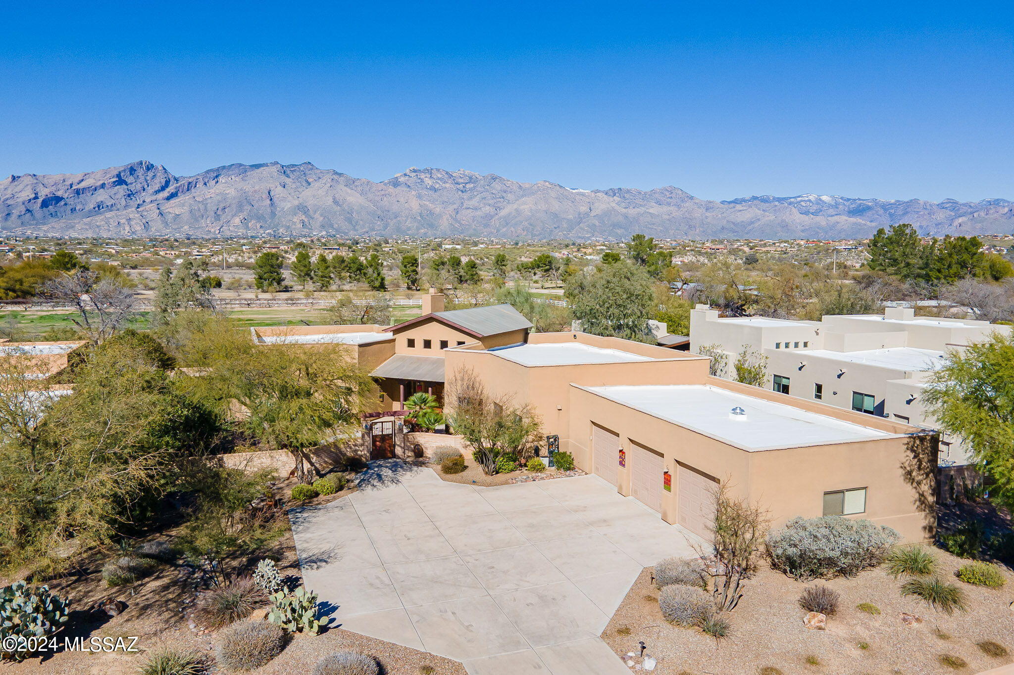 Sweeping Mountain Views From This Well Maintained 4 BR & 3 BA Home in the Coveted, Rarely Available, Parade Ground at Valley Ranch in the Old Ft. Lowell Historic District. Centrally Located, Gated Neighborhood Offering Brick Paver Streets, & Grassy Private Park. Fine Features Include: Courtyard Entry w/Custom Wrought Iron Doors - Concrete Floors - Plantations Shutters - Living Room w/Cathedral Wood Beam Ceilings, Custom Wood Cabinetry, & Fireplace - Formal Dining Room - Island Kitchen w/ Breakfast Area - Primary Suite w/2 Walk In Closets w/Custom Cabinetry & Bath w/Double Vanities+Jetted Tub - Laundry Room w/Sink - 3 Bay Garage w/Storage Cabinets & Climate Controlled Closet - Spacious Outdoor Living Area Offers a Wrap Around Covered Patio, Kiva Fireplace, and Panoramic Catalina Mt. Views!