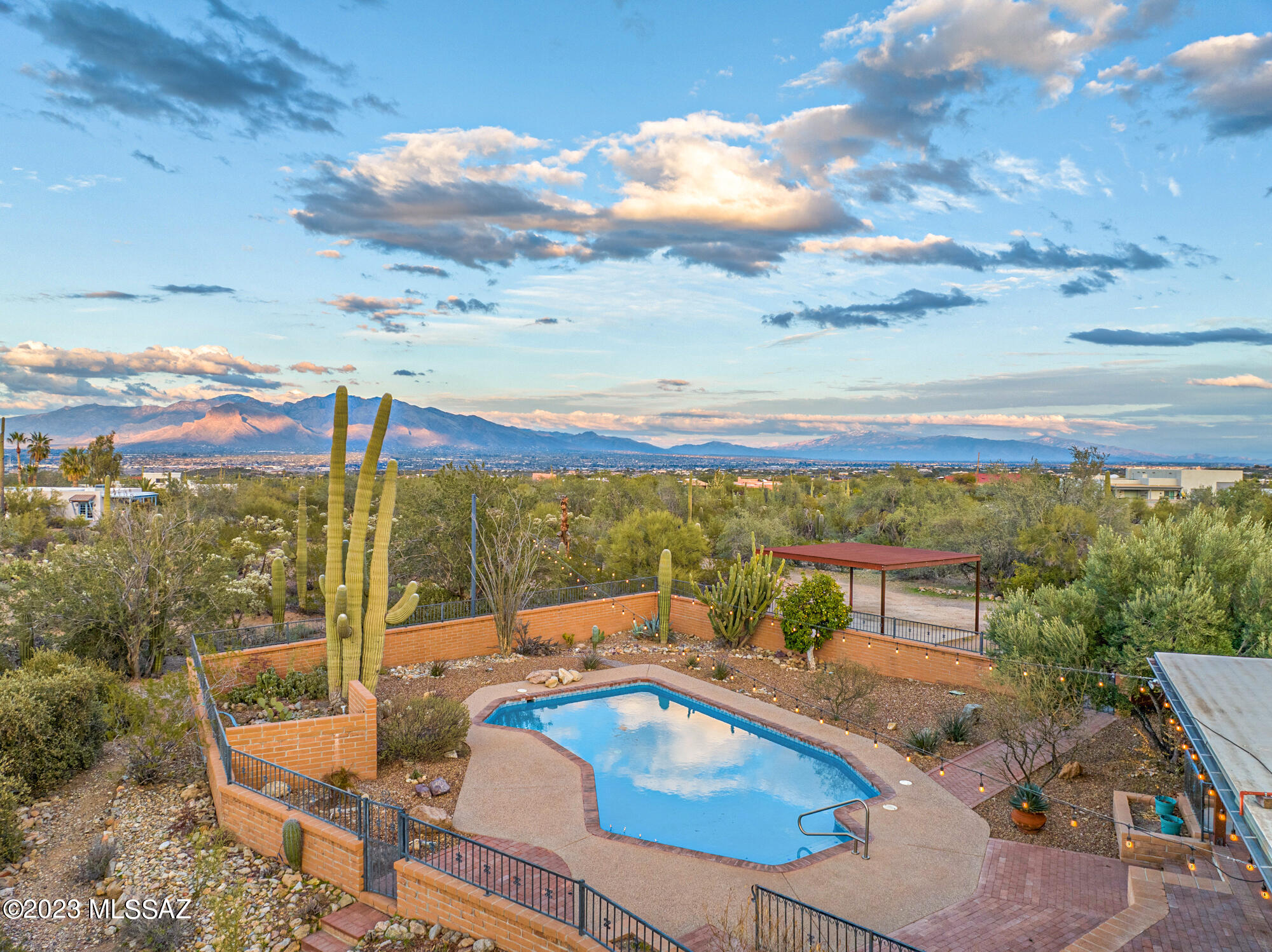 Beautiful, 4 bd, 3 bth updated custom home with gorgeous mature landscaping on over 3 acres of lush Sonoran Desert with impressive city and mountain views! This home is remodeled to perfection! Custom Iron double front doors w/window sidelights off a 75' covered front patio, 3 fireplaces, Spacious Kitchen w/tons of storage, granite counters, high end SS appliances. 4 sets of french doors leading to low care but colorful landscaping.  AMAZING newly plastered pool, 100' back patio, brick walkways and a bbq area.  All new doors & high efficiency windows, lighting fixtures, plumbing, 24'' tile in main living areas, 2 new baths w/Tumbled marble glass block accents, Executive Height cabinetry, slab Granite countertops, Beamed ceilings! RV set up w/slab. This home is a gem in the Tucson Mountains ready to move into and enjoy this desert oasis that is still accessible to all things Tucson!