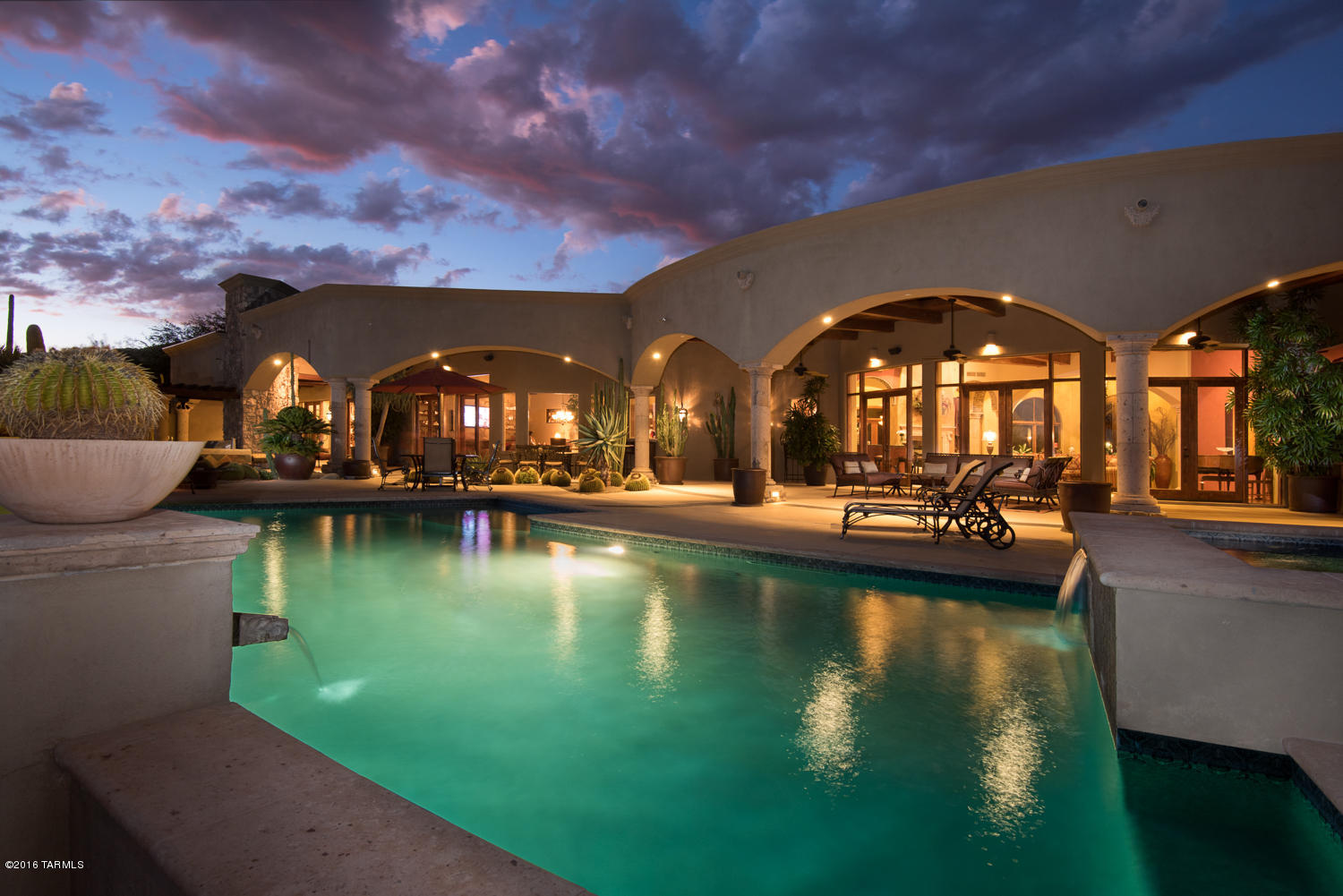 Welcome to 'Villa Santuario' This award winning Spanish Colonial resort style home has been featured in Tucson Lifestyle Magazine and Phoenix Home and Garden for outstanding design and landscape architecture, truly a masterpiece. Perfect views from every window and a private patio at each bedroom. Finishes rich in warm color and texture. An impeccably equipped professional kitchen, bar, formal and informal dining areas. Covered and open patios, pool, spa, outdoor kitchen and rooftop deck with a glorious 360 view. 9,000 + sq ft of indoor and outdoor living areas both formal and casual, 3 bedrooms- all ensuite,  a den and casita with separate entry.Lush, perfectly manicured grounds surround the estate, with nature paths, fountains and courtyard to enjoy the serenity of the desert.Read more Quality old world craftsmanship and exquisite detail resonate throughout this Spanish Colonial resort style home nestled in the Catalina Foothills. 
Custom designed by Greg Simmons and built by AB LeCocq with landscape by Tom Black, this home affords perfectly framed views from every window and doorway with a personal patio annexed from every bedroom.  You'll never tire of the breathtaking, extraordinary vistas of the Tucson basin and surrounding mountains. 
  
The interior finishes are rich in warm color and texture. Tumbled polished travertine and reclaimed barn wood compose much of the flooring, sometimes in tandem, lending unique interest to every room. Cantera stone columns and archways and solid Alder wood doors grace nearly every passage way.  Perfectly positioned on 3.71 acres this home is surrounded by $500,000 plus in custom landscaping  that seamlessly segues into natural desert surroundings.
This thoughtful and flexible home design encourages entertaining from an intimate gathering to galas on an elegant scale.  The impeccably equipped professional chef's kitchen, inviting bar, formal and informal dining areas will bring out your inner chef.  Outdoor living areas include covered and open patio areas, an enticing pool and eight person spa, a fully equipped outdoor kitchen and a roof top deck with a full 360-degree view of glorious mountain and desert vistas.
You and your guests will enjoy the 9,000 square feet of indoor and outdoor living areas, which have 4 bedrooms including a guest suite, a den, and 5+ bathrooms. There is absolutely nothing lacking in this extraordinary estate.