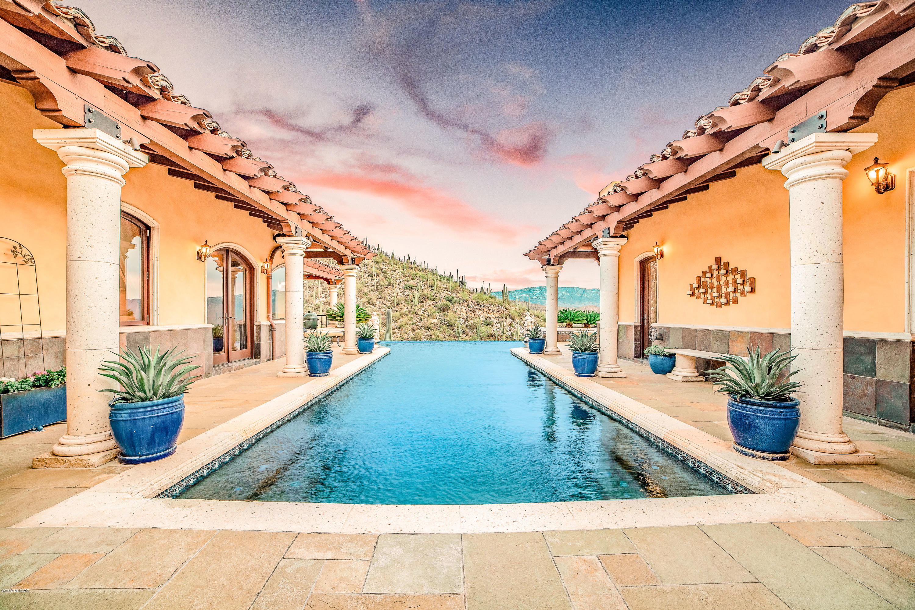 Perched high in NE Tucson in gated Milagrosa Hills, the view from this Tuscan Estate is like no other. Resting on just over 6 acres, experience the tranquility of living on top of the world. Extensively remodeled/rebuilt from top to bottom this 5,823 square foot home boasts 5 bedrooms, 5 well appointed bathrooms, a private gym & 4 car garage to fulfill all your desires. The chef's kitchen & butler's pantry are everything with multiple Sub Z's, LaCornue range, Landry Poplar custom copper hood, & more! The 1,200+ sqft owners retreat offers a private patio, accordion glass door access to the pool beckoning you to never leave. All custom mahogany woodwork throughout the home & an extensive amount of natural stone used inside & out. Extra lot would be great for horse facilities or guest house.
