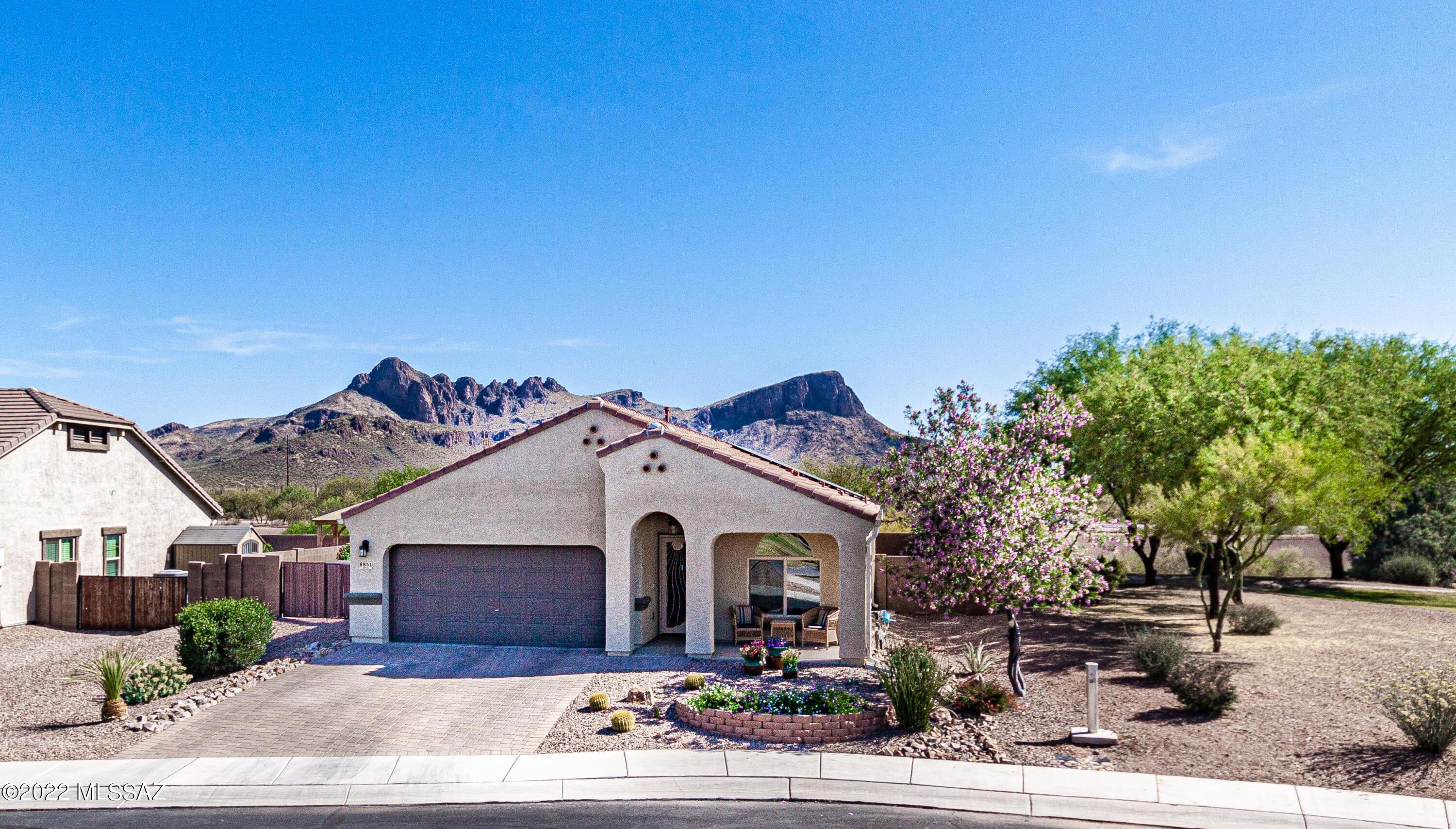 Delightful 5-bedroom 3-bathroom in the desirable sub-division of Saguaro Bloom. Open spacious floor plan with high ceilings. Large kitchen. Large walk-in closets. Breathtaking views of Saguaro studded hills. Leased solar panels. Recently installed Hunter irrigation. Quartz kitchen countertops are extended. Large kitchen island. The master bathroom has a door and a second sink. Ceiling fans with lights throughout the home. 6 minutes to I-10 and 12 minutes to Arizona Pavilions shopping center. Shows like a model home.