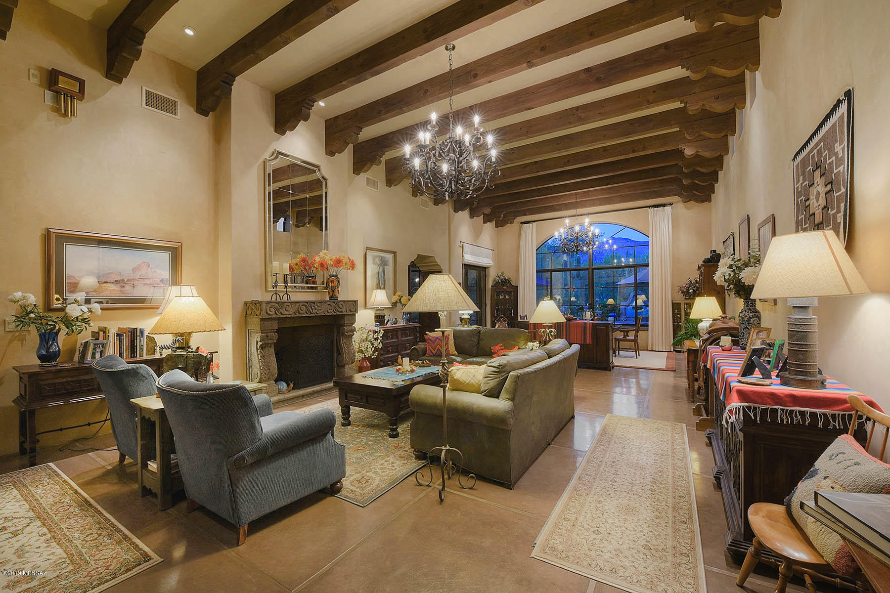 Stunning Jed Paradies designed traditional mud-adobe Territorial on a glorious Finger Rock view lot in the Old Foothills w/no detail left undone, 4207 sqft,4 bedrooms & 4 baths.  Courtyard entry w/brick walkway & fountain leads into living room with soaring ceilings & windows, scored concrete floors, imperial plaster walls, row upon row of beams with corbels, fireplace w/chocolate cantera surrounds & mountain views.Hand painted Mexican tile throughout. Gourmet kitchen/family room features scored concrete floors, beamed & corbeled ceiling, concrete & butcher block counter tops, stainless steel appliances, professional gas range, sitting area w/fireplace & built-ins.  Glorious master suite offers sitting room, walk-in closet w/generous built-ins, fireplace & master bath w/claw-foot soaking tub.  Wrought iron light fixtures, custom cabinetry, detail rarely seen in homes today, wonderful rear yard has expansive rear porch, grass area, gardens, pool, spa, fountain and so much more.  This is one home where words and photos to do not it justice.