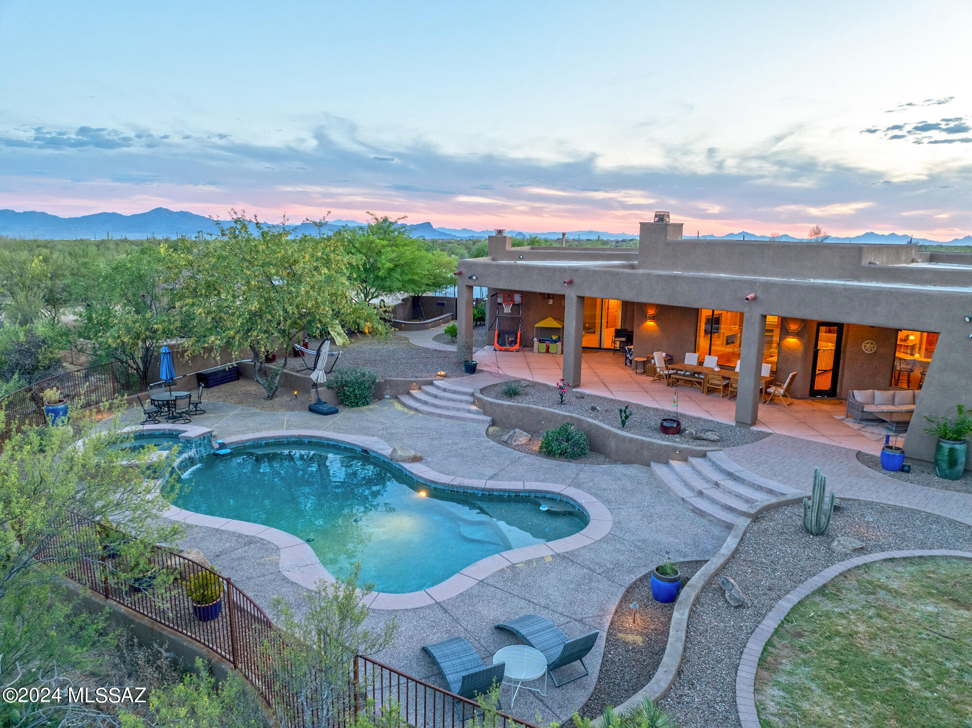 Experience the essence of vacation living with breathtaking mountain vistas right from your doorstep. Nestled on a sprawling 3.3-acre estate, this custom-built residence offers an unparalleled retreat. Boasting 4 bdrms, 4 baths & a spacious 4 car climate controlled garage, EV ready for 2 vehicles, pull thru door, cabinets & bathroom. Entertainers kitchen with center island & breakfast bar. Family room with built-ins. Great Room with covered ceilings, custom fieplace, windows framing mountains. Primary suite with fireplace,  bathroom with jetted tub, custom closet.with built in cabinets.   Unwind in the salt water pool, spa.  Outdoor kitchen, firepit. room to room with newly planted trees. Covered patio with fireplace. Laundry Room with built-in cabinets. Large secondary bedrooms. Additonal amenities include a charming chicken coop complete with chandelier and chickens.Outdoor playground. Gorgeous brick paver driveway with ample parking.  Concrete pad for RV