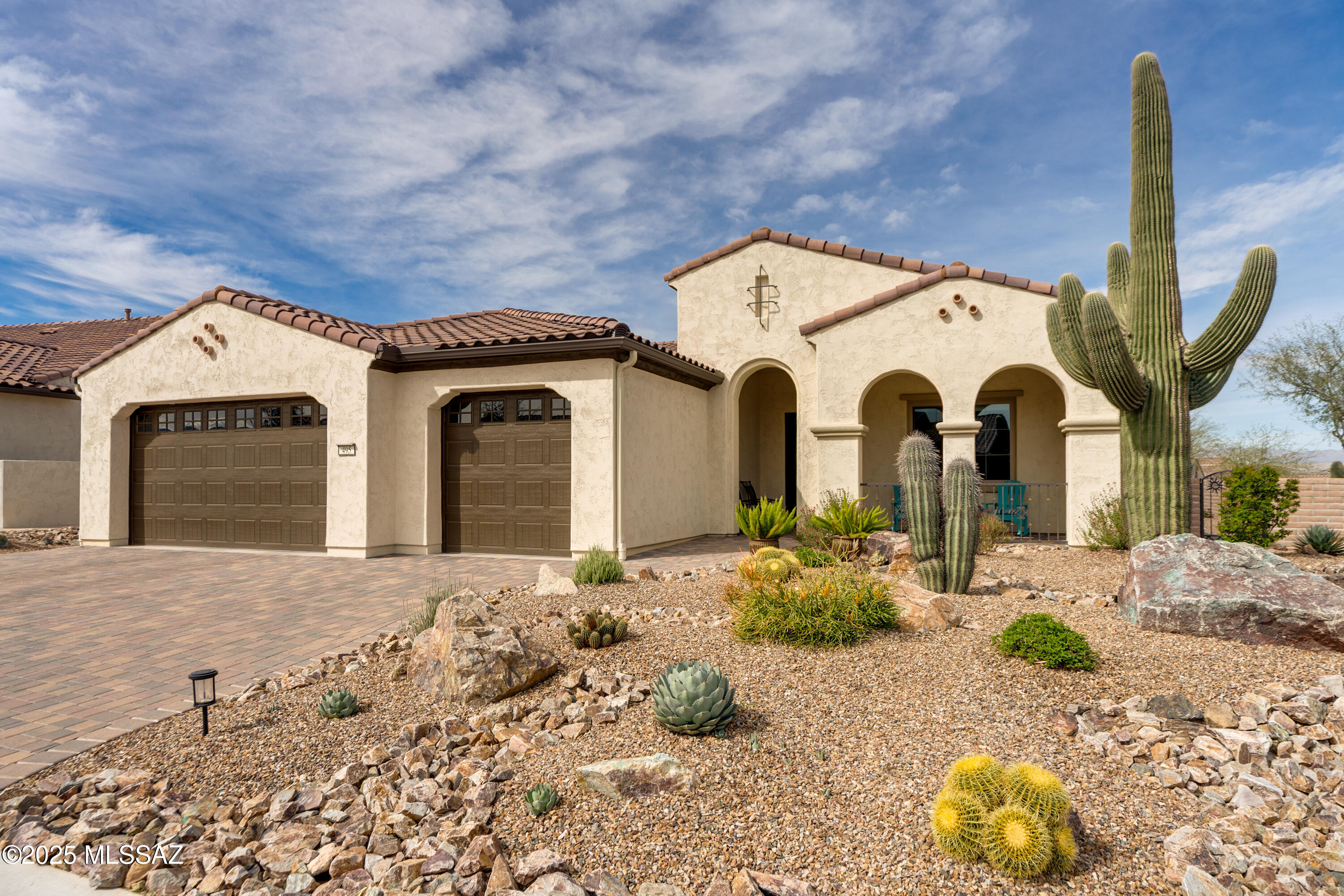 Live your luxury lifestyle! This stunning and spacious Avalon has it all! Built 2019, this 2,725 sq.ft. home resides on an elevated corner lot, where you are greeted by a majestic sahuaro as you approach the paver front porch. Step inside the grand foyer with plenty of space to display your fine art. Interior features incl. all hard surface floors (ceramic tile and luxury vinyl plank), spacious great room with dry bar, 3 solar tubes, upgraded fans and lighting, 5'' baseboards. Chef's kitchen w/ upgraded maple cabinets, leather finish granite counters, SS appliances, butler's pantry w/ walk-in food pantry. Bright and cheery owner's suite offers sunset views, and electronic window screens. Spacious owner's bath w/ dual vanity, WI closet and huge, walk-in/roll-in all-tile curbless shower. Den has 3' extension, ideal for both office, reading, TV viewing or casual living. Overnight guests will enjoy their own private suite w/ en suite bath and WI closet. Powder room and large laundry w/ sink and storage. Extended outdoor living space with paver patio, mountain views to the southeast, electronic screens, and plenty of space for outdoor dining, bird watching, and spectacular Arizona sunsets. Extended length, full 3-car garage has epoxy floors. Security screen front entry; rain gutters. Bonus: TEP GoSolar Home with 100% solar power, giving you low, fixed cost electric bills, all without rooftop solar panels.