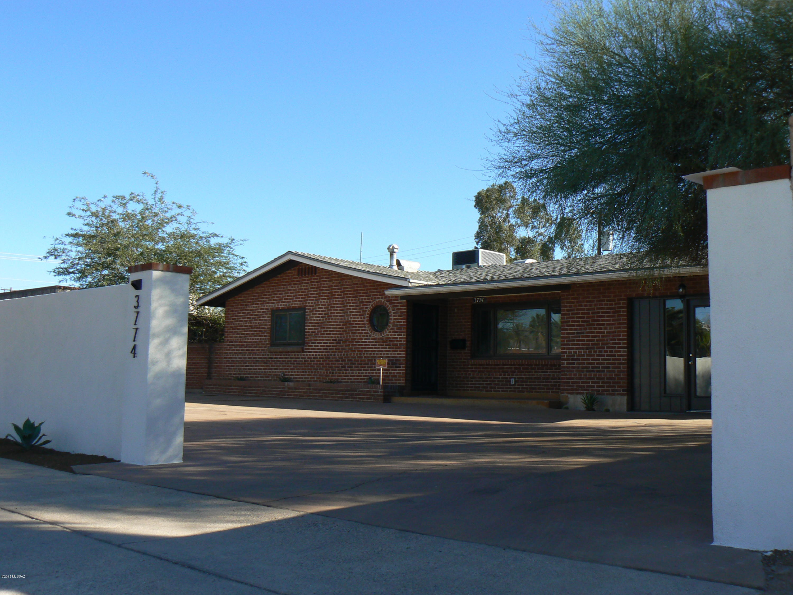 PRICE REDUCTION!!! Tastefully updated home just remodeled to create a more open living area while preserving the charm and style of a classic  brick ranch house.  Walls were removed to create a more open kitchen and French doors were added in the dinning area to allow for more natural light.  The Wood Parquet flooring has been refinished to a high gloss and the interior is freshly painted.  The old garage now bedroom/office is a permitted addition and the stucco wall was added for more privacy along the street.  New duct work was replaced to get a better air flow for the AC/heater. The carpet in the bedrooms are also new. The backyard offers options for outdoor enjoyment. Conveniently located to restaurants, movie theaters and shopping. It is an easy  2.25 miles bike ride to the U of A.