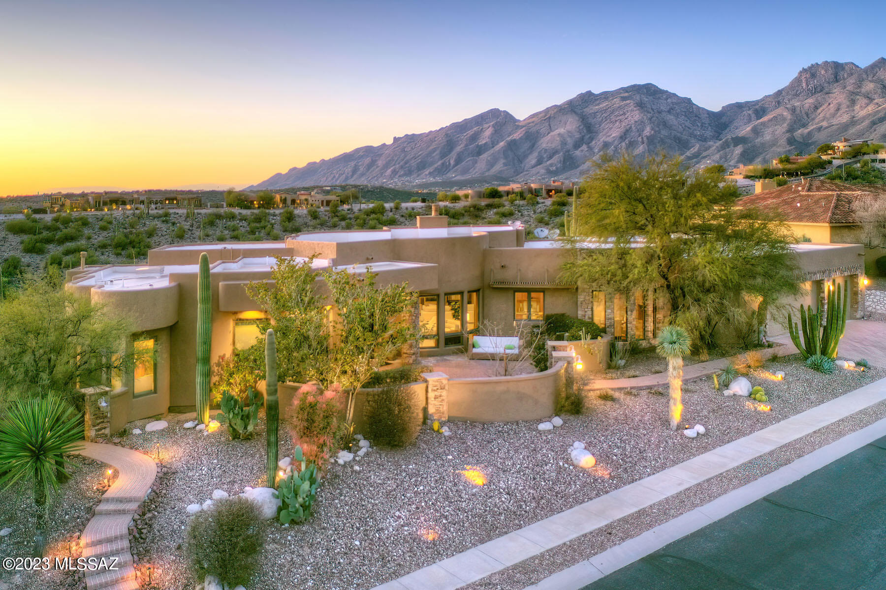 This stunning, custom J. Nichols contemporary is high on a ridge top lot and offers sweeping, 360 degree city, mountain, sunset & sunrise views.  Located in prestigious, gated Sabino Mountain, this 4,111 sq. ft. features and open & flowing great room floor plan with 13' soaring ceilings, travertine stone flooring, a dramatic fireplace, custom built-in accents, a gallery, a dining area and scenic views in all directions.  The fabulous chef's kitchen provides designer stainless steel appliances including a gas cook-top, cherry wood cabinetry, granite counters, a large center-island with a prep sink, a stacked-stone fireplace, and cozy breakfast area.  The handsome library/office offers custom cabinetry, bookshelves and a rolling ladder for those high shelves. The glorious primary suite features access to the covered back patio, and a luxurious bathroom complete with dual walk-in closets, dual vanities with granite counters, a bidet, a large walk-in shower & a spa tub.  Enjoy the beautiful back patio offering an expansive covered porch, cement paver flooring, a built-in BBQ, a pool/spa, a putting green, and breathtaking city & mountain views.  Highlights of the 3-car garage include generous built-in storage, a workshop area and a storage room.