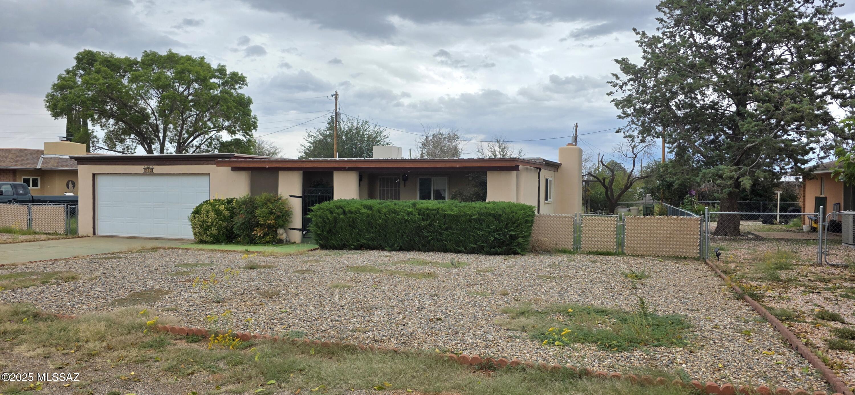 A generous 2,110 square feet of living space! This three bedroom, two full bath home offers a breakfast niche off the kitchen and a formal dining room with a wood burning fireplace. The bedrooms are spacious and the Arizona Room offers extra space for life's needed extensions. The square footage hinders not the coziness of this home. The laundry room has a sink, countertops and cabinets. The front porch is walled, gated with a slatted roof and planted vegetation. The perfect recipe for relaxation! There is a two car attached garage and an outbuilding with electric. For the outdoor enthusiasts..this home is located only a short drive from Cochise Stronghold.