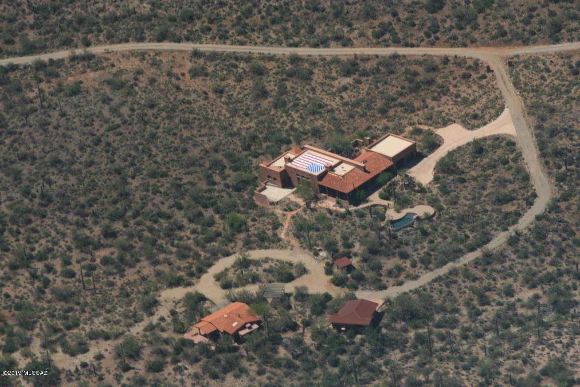 Spectacular desert sanctuary, located on 10+ acres of beautiful, natural Sonoran desert in the Tucson Mountains, near Saguaro National Park West and Sweetwater Preserve. Photos give only a hint of the attention to detail and the excellent choices made in design and construction to ensure comfort, privacy and views. The main house is 2600 sq. ft. with 2 bedrooms & 3 baths and has a large attached 2 car garage. The separate casita is 1100 sq.ft., 1 bedroom, with a full bath and kitchen. There's also a 2 car detached garage/shop near the casita. The casita is licensed by Pima County to be a bed and breakfast. there's a negative edge pebble-tec pool, a huge integrated rain catchment system, 2 outdoor showers and more.  Artistic touches everywhere. Call to arrange a visit.