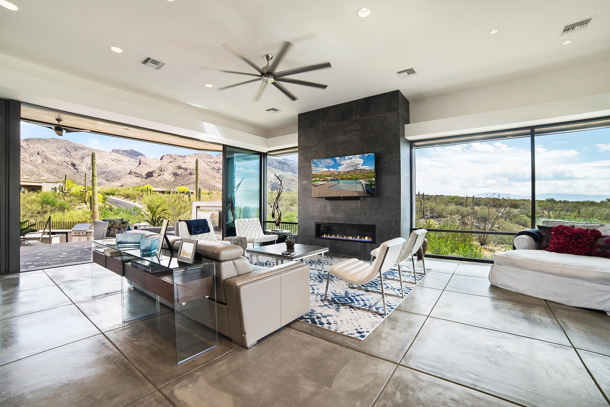 Modern living at its finest - this Marc Soloway designed “smart house” is a one of a kind must see! Nestled in prestigious Pima Canyon Estates, the home boasts views of both the city lights and mountains through floor to ceiling energy efficient commercial windows. Culinary enthusiasts will appreciate the top of the line Wolf Sub-Zero appliance package including wine tower. Spend beautiful desert nights enjoying the outdoor living space complete with large covered patio, 65” TV, full outdoor kitchen and fire pit overlooking the stunning solar and gas heated salt water infinity edge pool. The home features 4 bdrms and 4 baths, private office and a huge media room complete with a Sony 4K projector, 3 zone Sonos sound system, automated blinds and 8 HD camera security system, all accessi via phone or iPad. Equipped with LED lighting and AV pre-sleeves thru-out, this home is a modern day dream!