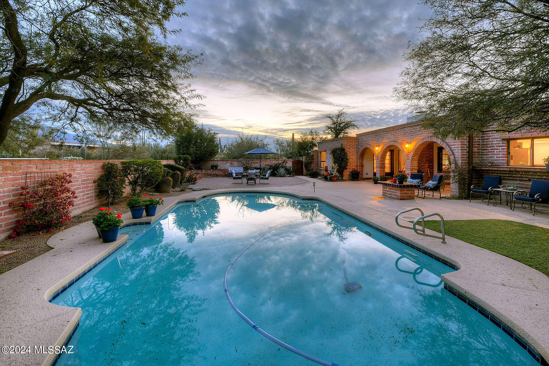I don't know what defines a ''Tucson Lifestyle Home'' but this is it.  Nestled on over and acre in the old foothills with a backdrop of the Catalina Mountains.  A beautiful remodeled cooks kitchen. a separate guest suite with bathroom (nice for an office as well), owners suite with such a unique reinvented bath, and still 2 additional bedrooms and bath.  I love the formal living room and dining room that feel anything but formal,.  Inviting family room anchored by a true fireplace.  Outdoor living? think serene...  pool, privacy, deep covered patio, and even an open brick patio just perfect for that first cup of coffee or that evening cocktail. I try to stay neutral but I love this and you will too.