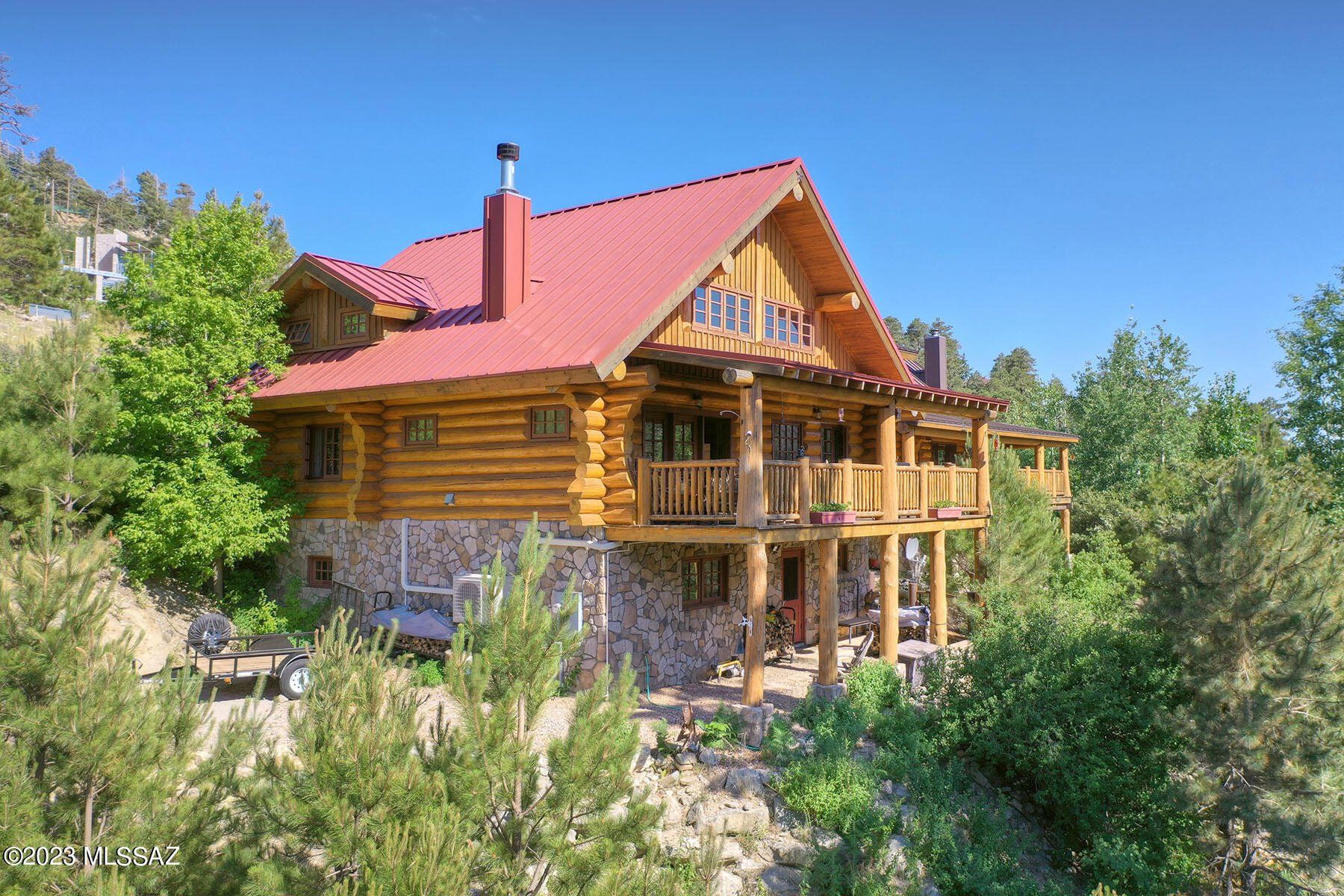 Escape to your personal oasis at Northstar, a charming log cabin nestled in the trees on the picturesque Mt. Lemmon. Knowing that this incredible home in the cool pines is waiting for you can absolutely change your life just like it did for its current owners.  This 4-bed, 2-bath sanctuary offers a tranquil retreat from the Tucson heat, where you can unwind on the covered porch, relishing cool breezes that are 30 degrees cooler than the valley below. Whether you're accompanied by loved ones or savoring your solitude, the 2700 sq ft of well appointed rustic elegance provides ample space for relaxation & reflection. Genuine log cabin, a rare find. Plus the sellers have purchased & improved 2 adjoining lots. Paved Drive. 8 easy parking spots.One owner is a licensed Real Estate in Arizona. The cabin's inviting interior exudes warmth with its stone fireplace and abundance of natural building materials, making winters cozy and enchanting. Modern amenities abound, as the current owners have thoughtfully incorporated remote-operated heating and cooling systems, ensuring your comfort is just a click away. With a double lot for parking and enhanced privacy, you'll revel in the serenity this property offers.

The possibilities are endless at Northstar - host family gatherings, create lasting memories with your kids and grandkids, or use it as your tranquil escape to recharge from the hustle of daily life. This turn-key gem, thoughtfully maintained by a licensed Arizona real estate professional, awaits its new owner to bask in the year-round allure of Mt. Lemmon. Don't just imagine it; make this dream cabin your reality and embrace the harmonious blend of nature and charm!
Genuine log cabins on the market are few and far between. This is a rare opportunity. Enjoy the craftsmanship of a genuine log Cabin. Like living in a piece of art. Typically log cabins are priced higher than frame or log clad homes. This one isn't. It's priced to sell. 
Welcome Home!