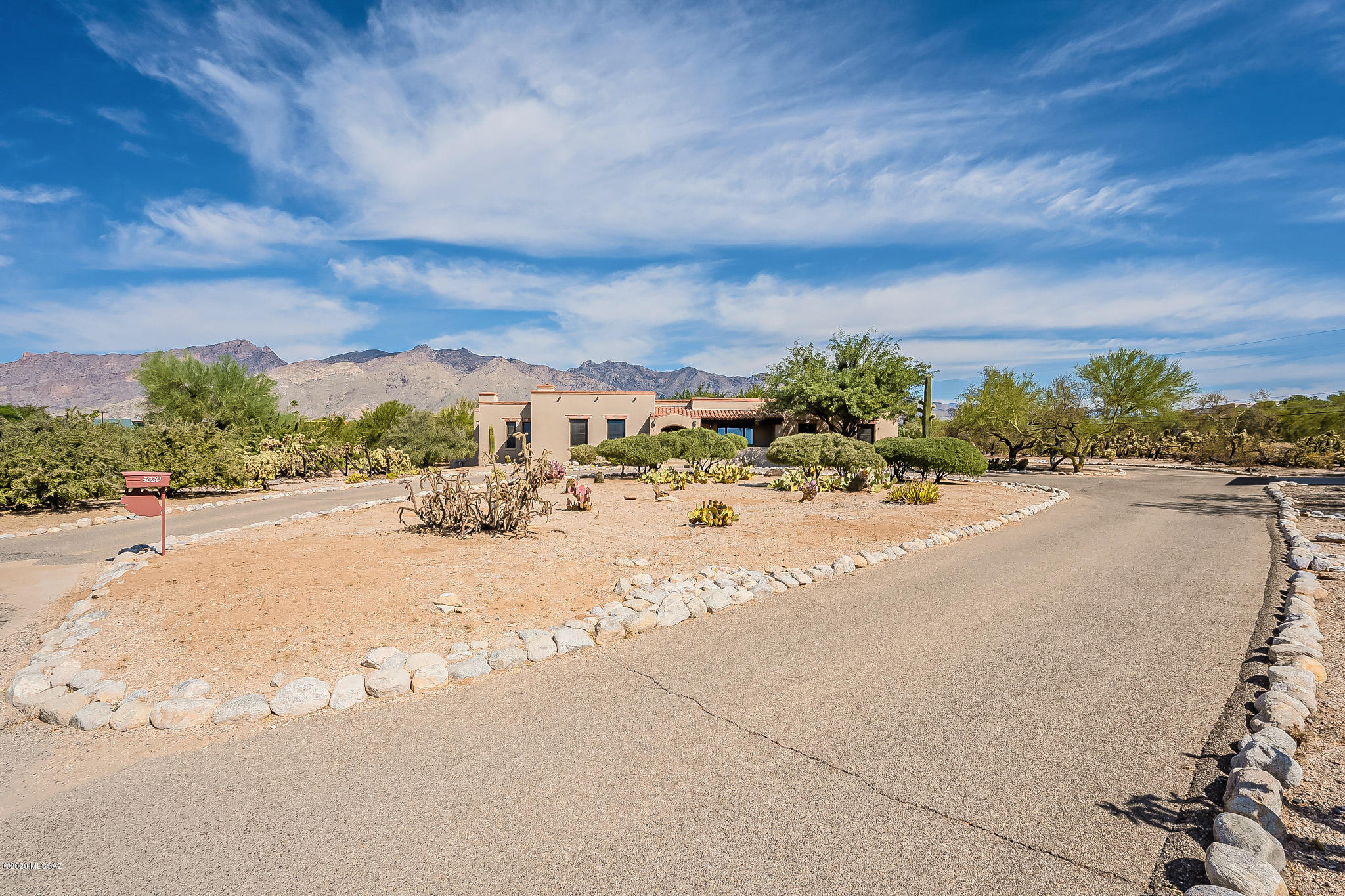 Beautiful quiet setting at end of cul-da-sac, surrounded by mountain views on over an acre. Quality construction thru-out this custom masonry home. Hard to find split plan 4BR + cozy den w/fireplace in master wing. (great home office) Kitchen w/island & charming eating area overlooking backyard. Spacious family room, formal living w/beam ceilings & fireplace. New wood floors in bedrooms, living & dining rooms, solid wood doors & casement windows. Master suite w/awesome views, double closets &  private outdoor living w/big, deep covered patios, mature plantings, brick paver patios, turf & plenty of room for pool. Great storage thru-out home & garage. Additional, newer, cooled, detached garage could be converted to guest house, home office, workshop – endless possibilities. Original Owner.