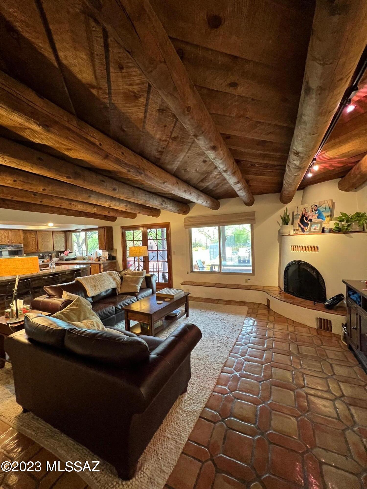 Lovely Southwestern/Santa Fe contemporary home in sought after Shadow Hills. Located in the Catalina Foothills, this home sits on almost an acre- private lot. Enter the front courtyard through a blue gate, 4 large bedrooms, 2 full baths, updated kitchen w/silestone countertops, stainless appliances, GE Profile double oven, High ceilings, saltillo tile, Wood floors w/carpet in two of the bedrooms, split floor plan, wood beamed ceilings with rough hewn ceiling planks in family room, lots of charm. Dual Pane windows, Owned Solar, and wired for Elec car charger in garage . Entertainers delight out back with pebble tec pool, spacious extended covered patio, built in gas bbq, outdoor fireplace, gorgeous views & mature landscaping. Very sought after neighborhood close to restaurants & more