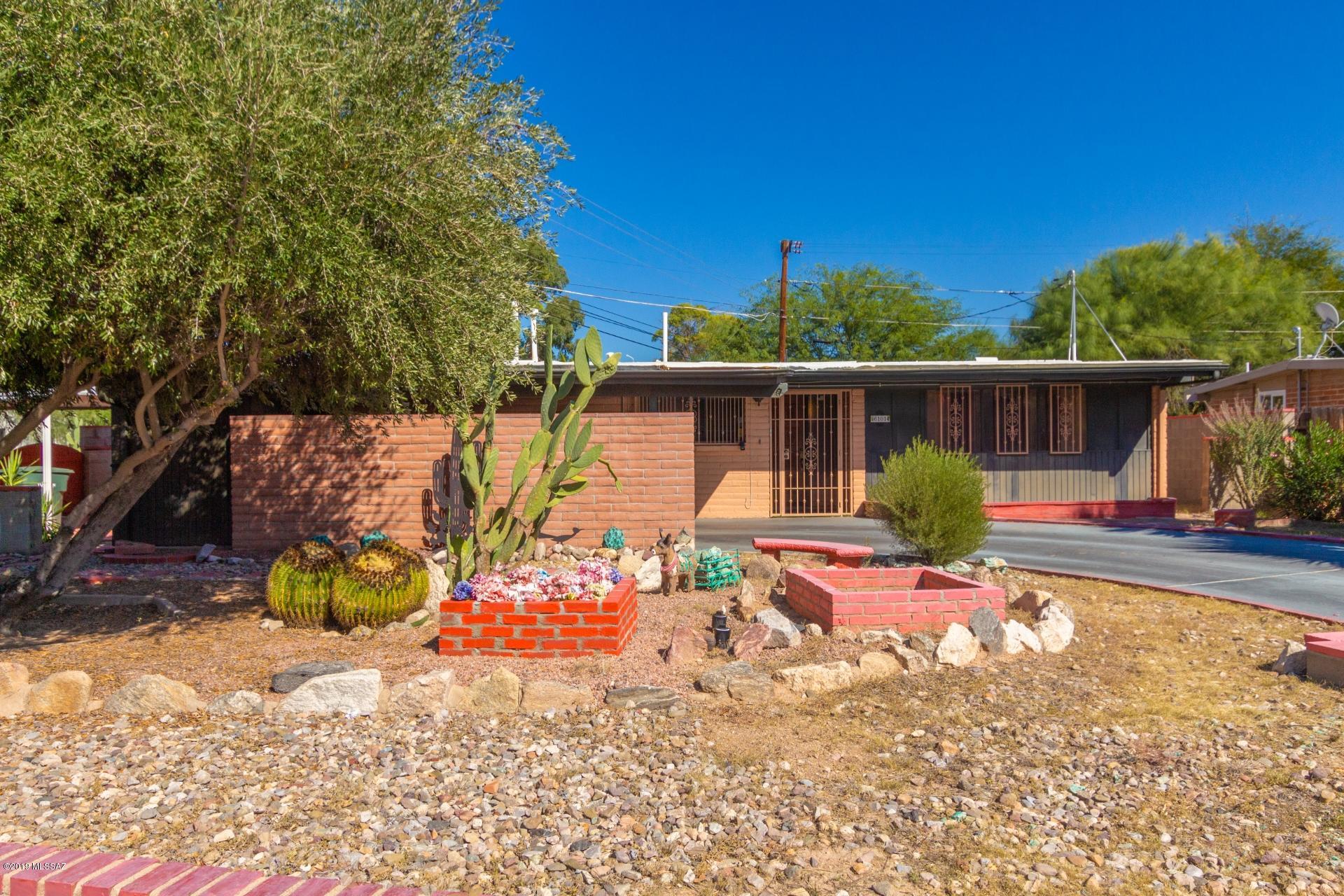 Vintage lover's delight! Original kitchen and bathrooms. Very charming centrally located Tucson home available on an ideal corner lot in desirable Rose Hill Estates. 3 bedrooms/2 bathrooms. Spacious living and family room. Kitchen offers plenty of cabinet and counter space and a breakfast bar. Master bedroom includes a private 3/4 ensuite and a sliding glass door to exit to the rear patio. You will love the large, low maintenance backyard which is fully enclosed with block fencing and perfect for pets, playtime or entertaining. Savor beautiful mountain views while relaxing on your own covered patio. All conveniently located within blocks of shopping and restaurants and just minutes from the UofA and downtown Tucson. This gem will sell in a flash. See it and make it yours.