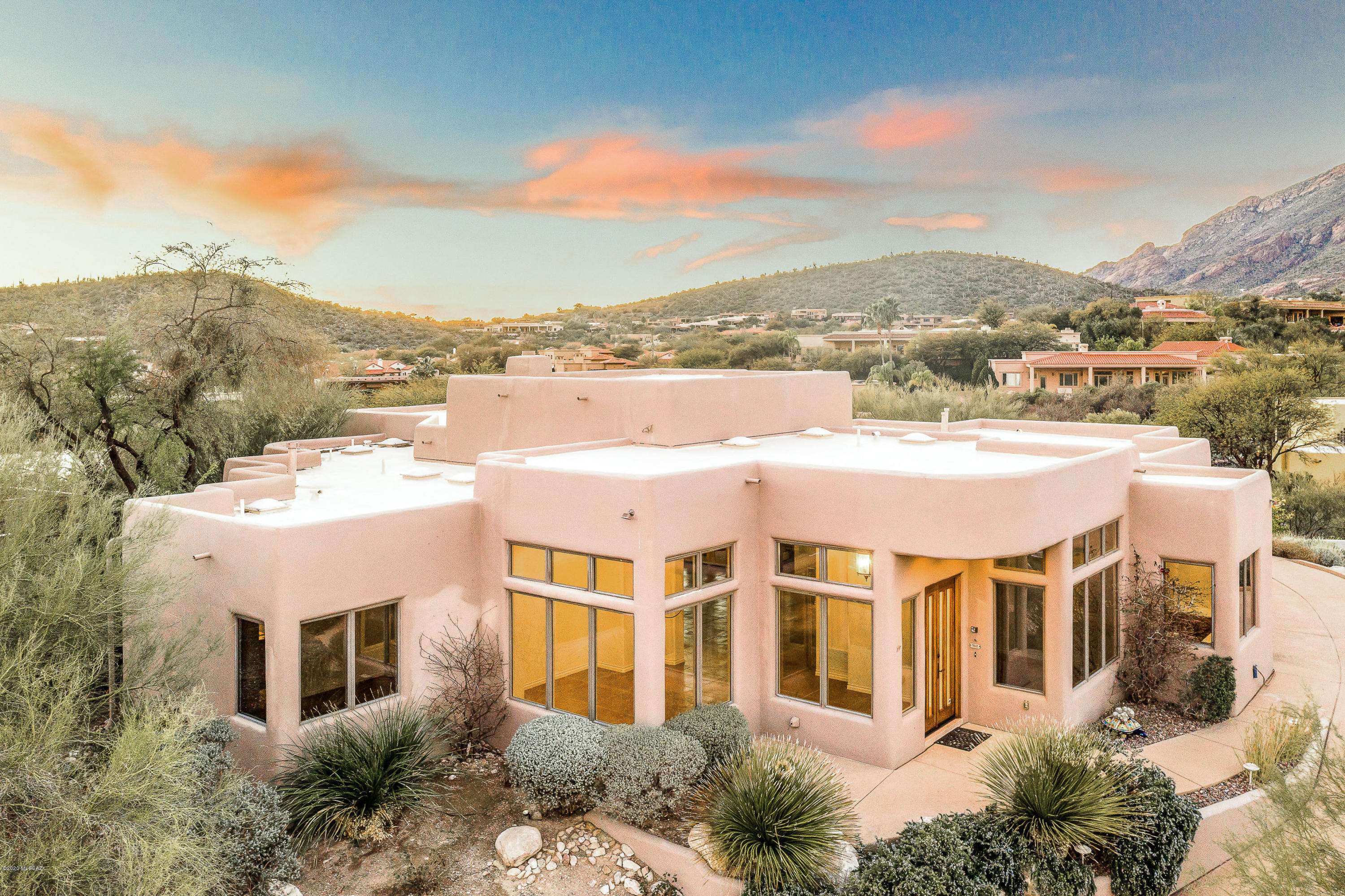 Stunning SW contemporary home in Ventana Entrada~an exclusive gated enclave within Ventana Canyon Country Club! Featuring many timeless finishes~concrete floors, a touch of Mexican tile, knotty alder doors, wrought Iron fixtures and hardware. This 3 Bedroom, 3 Bath home is immaculate and has everything you could need for our casual Arizona lifestyle~3,036 SqFt, Open~Greatroom concept, Split bedroom plan, Formal Dining, Eat-in Kitchen, Spacious Laundry/Art Room, Bee Hive Fireplace, Soaring Ceilings, Walls of Glass and Patio Doors, Intimate Patio with Pool, Spa and Built-In BBQ, 3 Car Garage with Storage. Sitting high within the subdivision, this home offers dramatic views, privacy and serenity! Superior location,  Dist#16 Schools