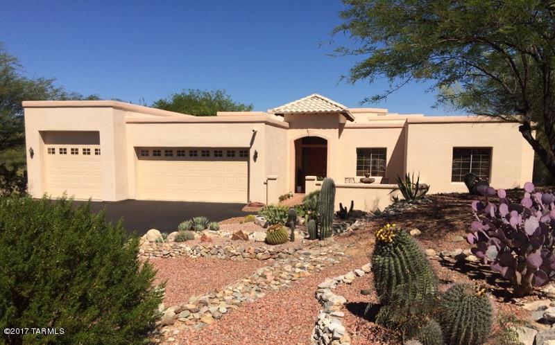 Impressive 2,620 SF, 3BD/2.5BA home situated on nearly half an acre of lush, saguaro-studded land in sought-after Sunridge II subdivision. Enter through a brick-paved courtyard featuring a fountain, seating area, and flower planters, past an 18' exterior entry foyer with an 8' solid cherry door & custom stained glass windows. Home features custom cherry cabinets throughout with brushed nickel hardware. Gourmet kitchen boasts all SS appliances with new custom glass tile backsplash. Large 3-car garage with RV parking & electric hook-up, newer gas water heater & 16-SEER Rheem gas heating & cooling with SMART thermostats. Backyard oasis with diving pool, new Baja jump board & fountain. Grass area and raised fire pit, covered patio, electric & cable! This home is one-of-a-kind. Welcome home!