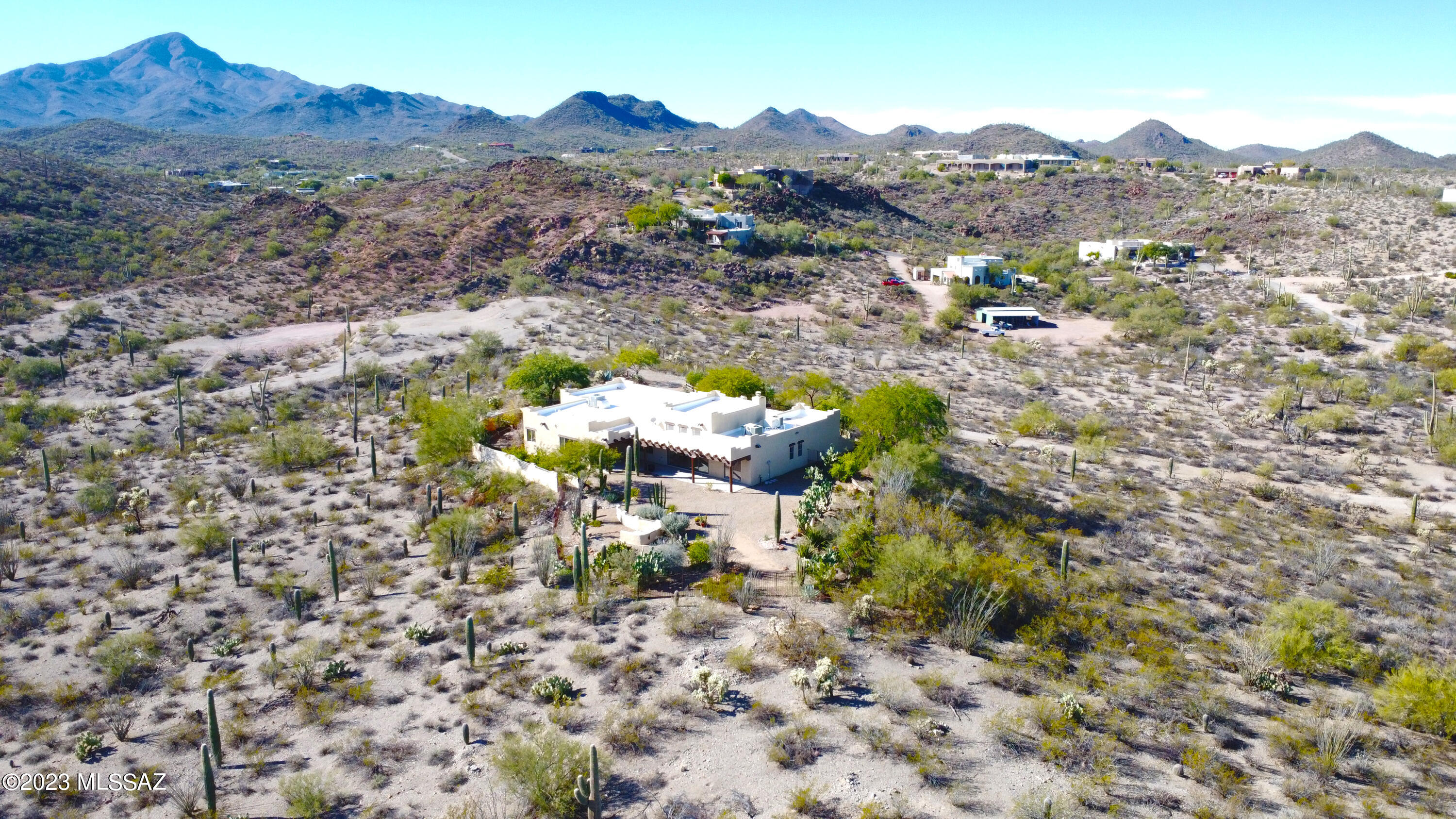 A million dollar property priced VERY low to allow you to make optional cosmetic updates. This is a rare hilltop view estate set on a very private 3.3 acre lot in the heart of the West Tucson Mountains. NO HOA & close to Saguaro Nat'l Monument Park! This Santa Fe style home was made with ultra high efficiency block construction & large spaces in mind. The split bedroom/open concept floorplan was ahead of its time and mimics many new construction layouts. New interior paint and carpet in the bedrooms make this home completely move-in ready. If you value an enormous garage, a large primary closet, tall ceilings and elevated views of the city & Catalina Mountains, this is your place! Gardeners will be delighted with many established specimens throughout the grounds.