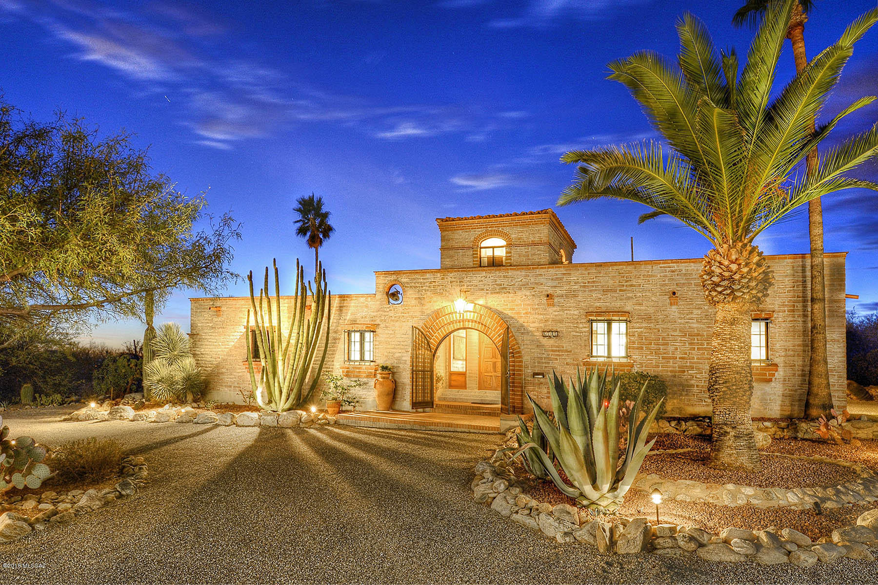 Renovated to perfection, this classic territorial boasts marble and concrete scored floors, rustic wood beamed ceilings, exposed brick, incredible city AND mountain views, & a clean, cozy vibe that blends Restoration Hardware into a classic Arizona home. All baths are brand new w/generous use of marble & custom cabinetry; sunny open entertainer's kitchen w/pass through to dining, & the separate guest quarters have their own entry with marble steps leading the way into a beautiful space w/spectacular views. North facing side yard has a charming fire pit perfect for watching the sunset dance across the Catalina Mtn range. Home is believed to have been designed by the famed Howard Curtain, or at least heavily influenced by him.  Owners never meant to leave so all finishes are top-notch WOW!