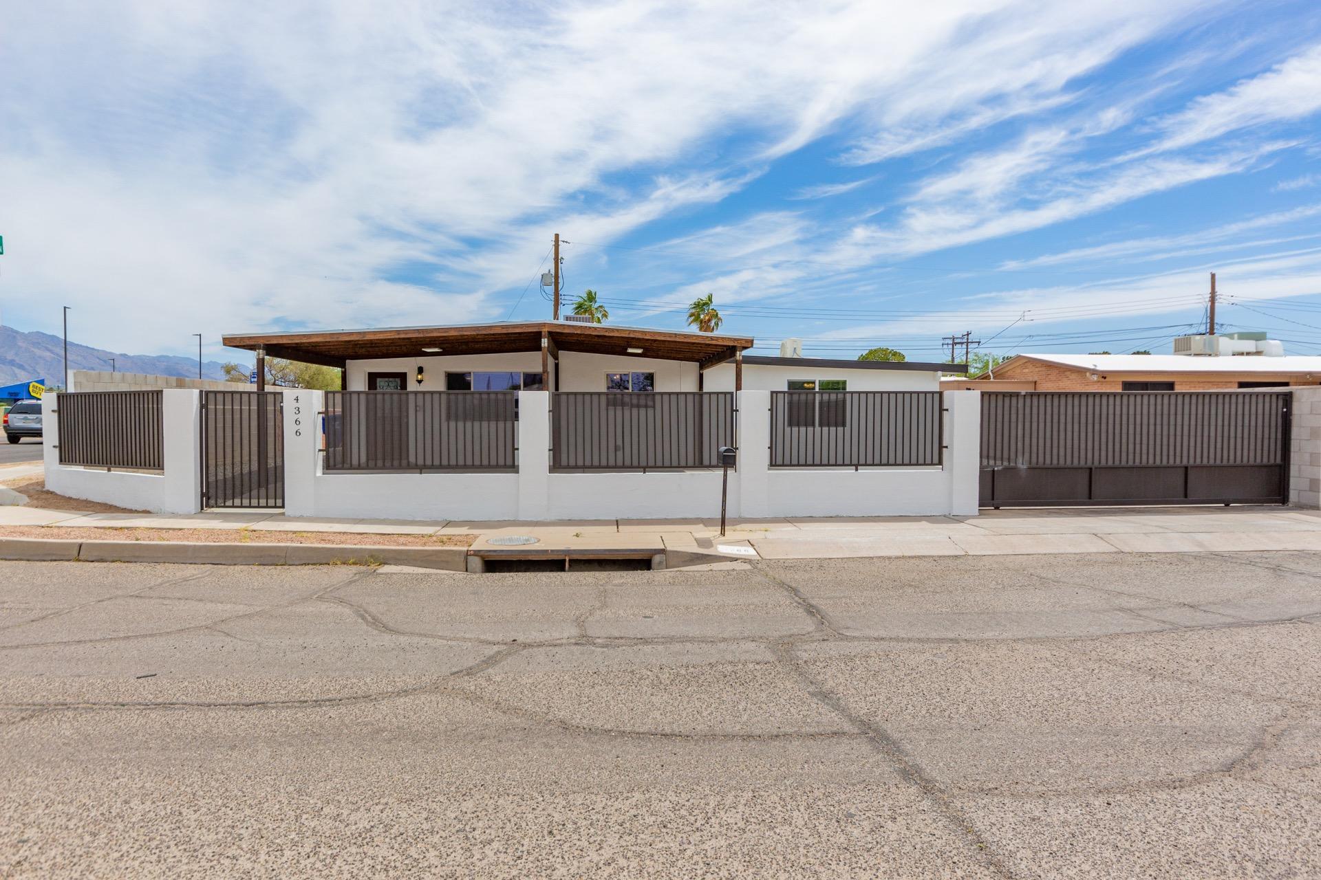 Beautifully Remodeled home on a corner lot w/a wrought iron/stucco gated entry. RV Gate & Parking. Gorgeous new  wood ''look'' tile floors throughout, crisp new palette, new ceiling fans, & new window blinds. This great room floor plan features a stunning new kitchen w/granite counters, breakfast bar, SS appliances, new double sink, & handsome new wood cabinets w/hardware. Generous size bedrooms, ample closets, impressive new baths w/granite counters, designer tile, & an interior laundry room. Master retreat boasts a private upscale en suite. Large yard w/decorative stone, covered patio, & room for your toys! Storage shed.  This desert gem will not disappoint!