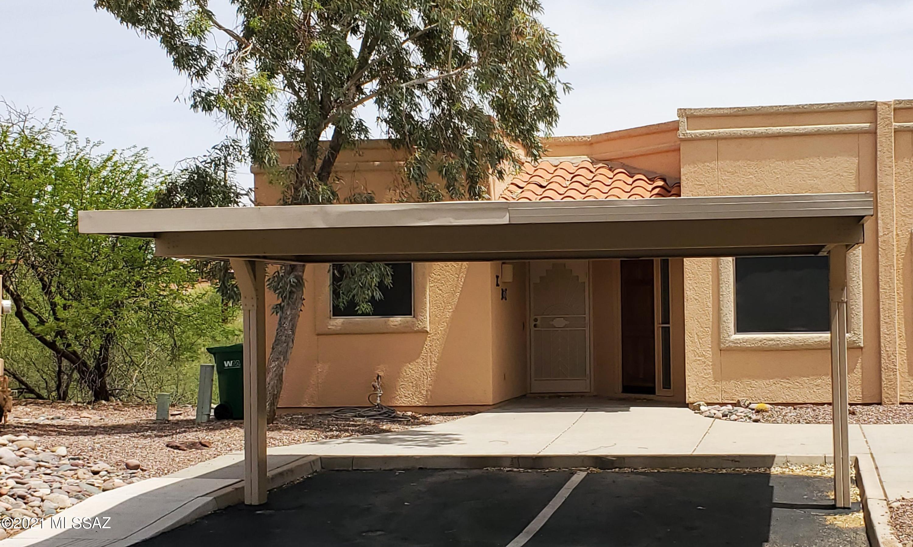 This Unique 1,221 sq ft Townhome has 2 bedrooms, 2 baths; 1 of which is a lock-out with a Separate Entrance which can be used for guests or as a rental unit for extra income while living comfortably in the main Villa, or vice versa, with Carports Available in front. Updated Open Concept Living/Dining & Kitchen with Ample Cabinets & Granite Countertops! Main Bathroom is Handicap Accessible with a Handicap Vanity & Roll-in Shower. Stacked Washer/Dryer. Upgraded Tile Flooring throughout other than carpet in the bedrooms. All Furnishings are Available Via Separate Bill of Sale inc. the Electric Fireplace. Roof Recoated in 2021. The Back Patio overlooks a Lg Arroyo & the GVR is within walking, biking, or driving distance + there are several golf courses nearby. The Green Valley Lifestyle Awaits