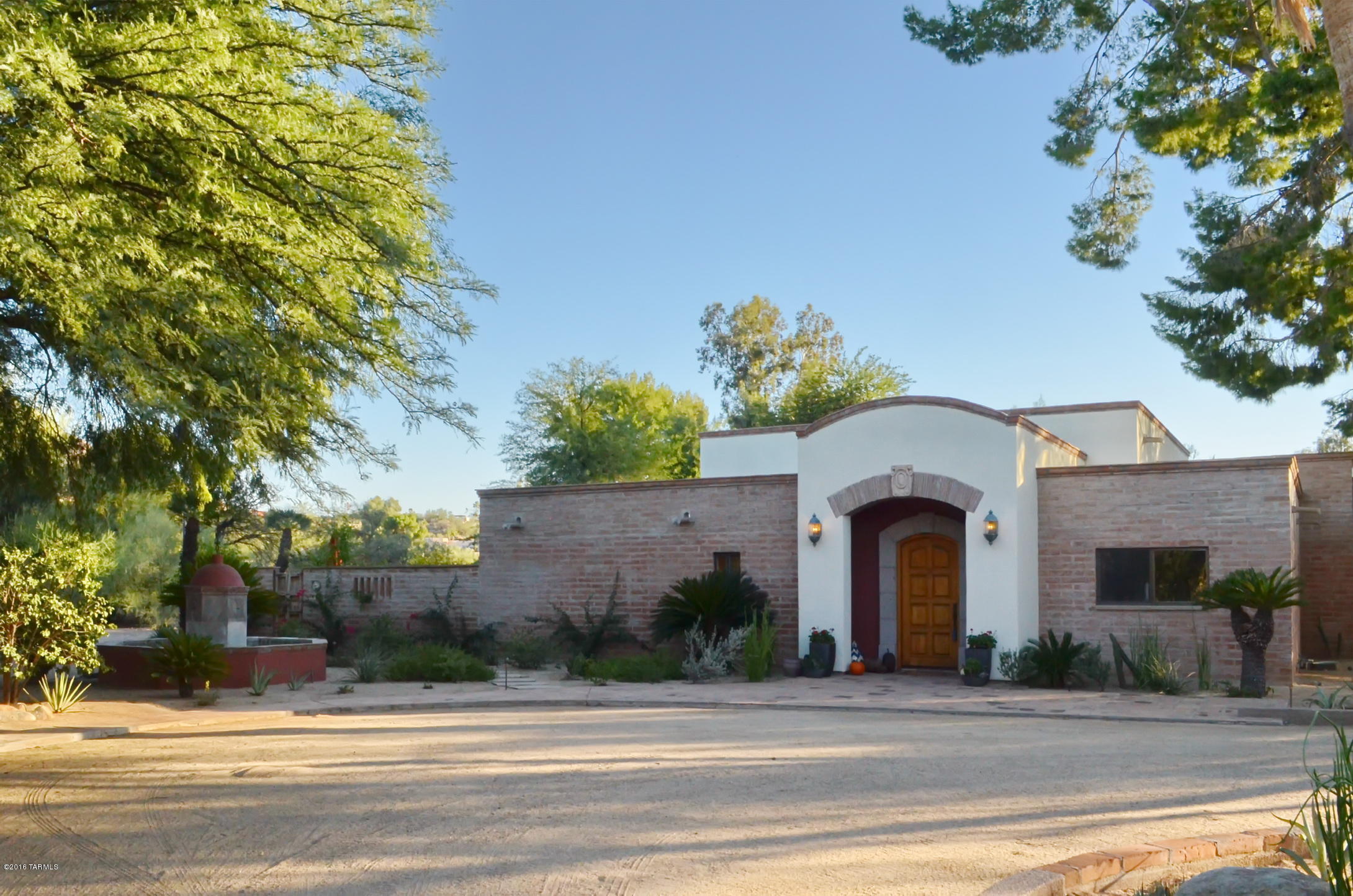 Unrivaled residence, sited on one of the finest lots in Oro Valley Country Club, surrounded by golf course. Fabulous cul-de-sac lot with up close views of Pusch Ridge. Grand entrance boasts soaring beamed ceilings, three sets of french doors flood living and dining rooms with light and tremendous views. Canterra stone fireplace is the place to gather family and friends. Beautiful solid wood interior doors, burnt adobe construction with some exposed adobe interior walls, warm Saltillo tile flooring pairs wonderfully with wood and travertine throughout. Large open kitchen with fabulous island, another terrific place to gather. Kitchenaid refrigerator, chef level DCS six burner, plus griddle, gas cooktop, plus double oven. Cozy den/tv room the perfect place to unwind with family and friends.