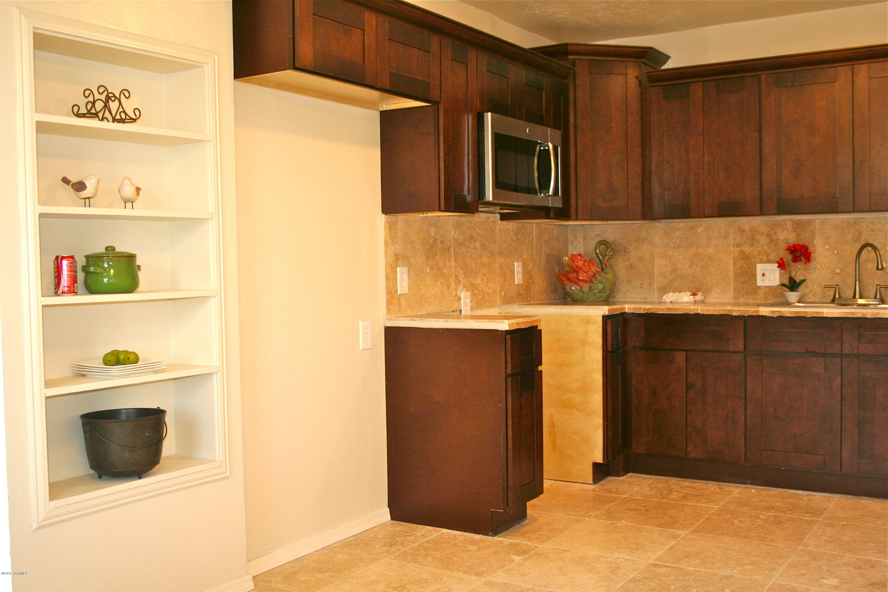 Best Buy on the South side! This Solid Brick home has it all.  Huge .37 acre lot, Brand New four ton A/C unit, Brand New Dual pane windows, Ceiling fans, Light fixtures, Doors, Carpet, Natural Stone tile,Brand New Koville Cabinets featuring self closing drawers & cabinets, Natural Stone Tile counter tops, Fresh paint inside, and New stucco and paint outside. Newer Roof done three years ago, Seller will provide a two years warranty. Large Master suite, so big it has two ceiling fans, offers a walk in closet, high ceilings, brand new bathroom, and a exterior door. Big indoor laundry room w/storage space. Plus Two BONUS rooms, one in the house off of the Master suite and the other is a free standing room outside that was once a church. Nice big dog run. You can never have too much space!