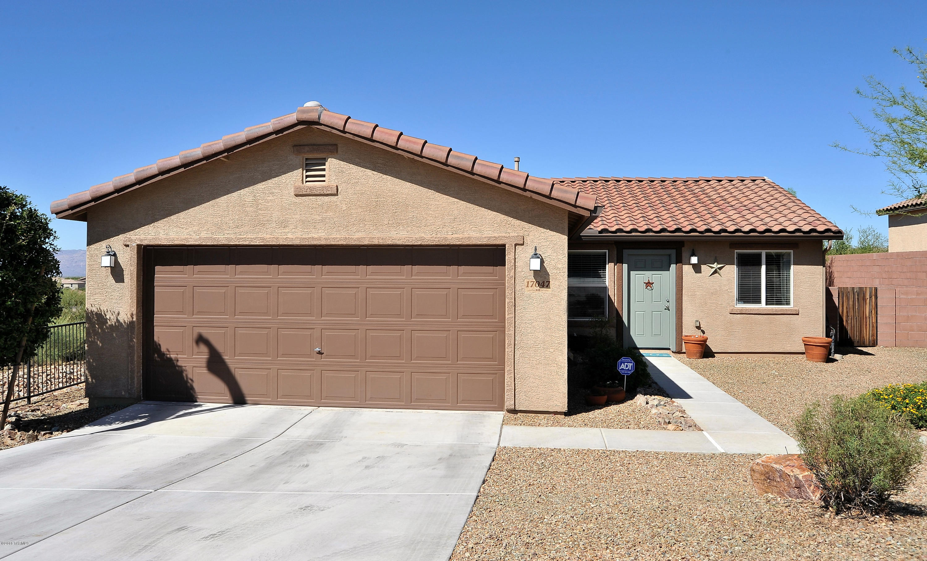 Views, Views, Views!!!  Former model home features 3 bd/2ba in the award winning Vail School District. This home has a nice contemporary feel with polished concrete floors, decor colors, new ''wood'' ceramic tile in baths & an open floor plan.  Large kitchen w/gas stove, plenty of cabinets & huge pantry opens to great room.  Upgrades include ceiling fans, surround sound speakers & custom wall unit in hallway-perfect for backpacks!  Remodeled hall bath w/pedestal sink, new mirror & light fixture.  Large landscaped back yard perfect for entertaining & a place for the kids to play.  Great sitting area around fire pit is perfect for taking in the magnificent sunsets & mountain views.  No neighbors behind, corner lot & views for miles!!