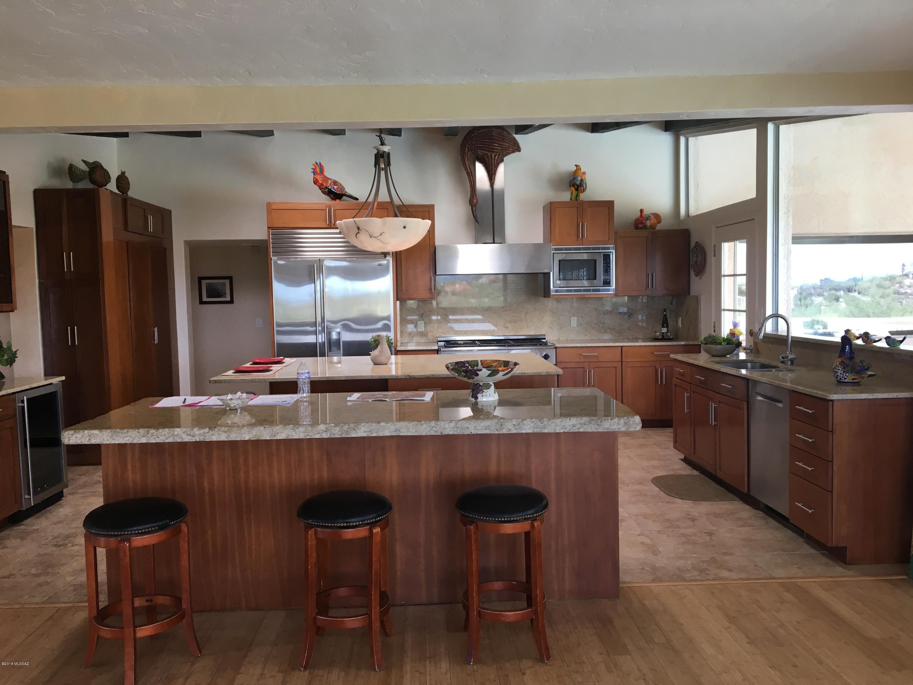 OPEN SUN 3/17 FROM 2 TO 4!CLASSIC MID CENTURY TUCSON HOME W/ ALL THE MODERN UPGRADES IN UNIQUE COBO CATALINA ESTATES. ENJOY QUIET PRIVACY ON 5.85 ACRES IN A NEIGHBORHOOD WHERE ALL HOMES ARE ON SIMILAR ACREAGE. EXQUISITE 360 DEGREE MTN/CITY VIEWS (ESPECIALLY FROM ROOFTOP DECK!) YET CENTRALLY LOCATED ONLY 20 MINS FROM DOWNTOWN & UA. 3 VERY LARGE BRS/BAS IN MAIN HS PLUS 1 BR/BA IN ATTACHED CASITA. GRANITE COUNTERTOPS, BAMBOO & TILE FLRS THROUGHOUT. CHEF'S KITCHEN W/ DACOR DOUBLE OVEN, SUB ZERO FRIDGE, BOSCH D/W & 2 LARGE GRANITE ISLANDS. HUGE COVERED PATIO IDEAL FOR SHADED OUTDOOR ENTERTAINING WHILE ENJOYING MAGNIFICENT CITY & MTN VISTAS. SPARKLING POOL, SPA OFF MSTR PATIO & JACUZZI TUB. CORRAL, TACK SHED & TRAILS SUITABLE FOR MANY USES.  LOVED RAISING MY KIDS ON THIS WONDERFUL PROPERTY!
