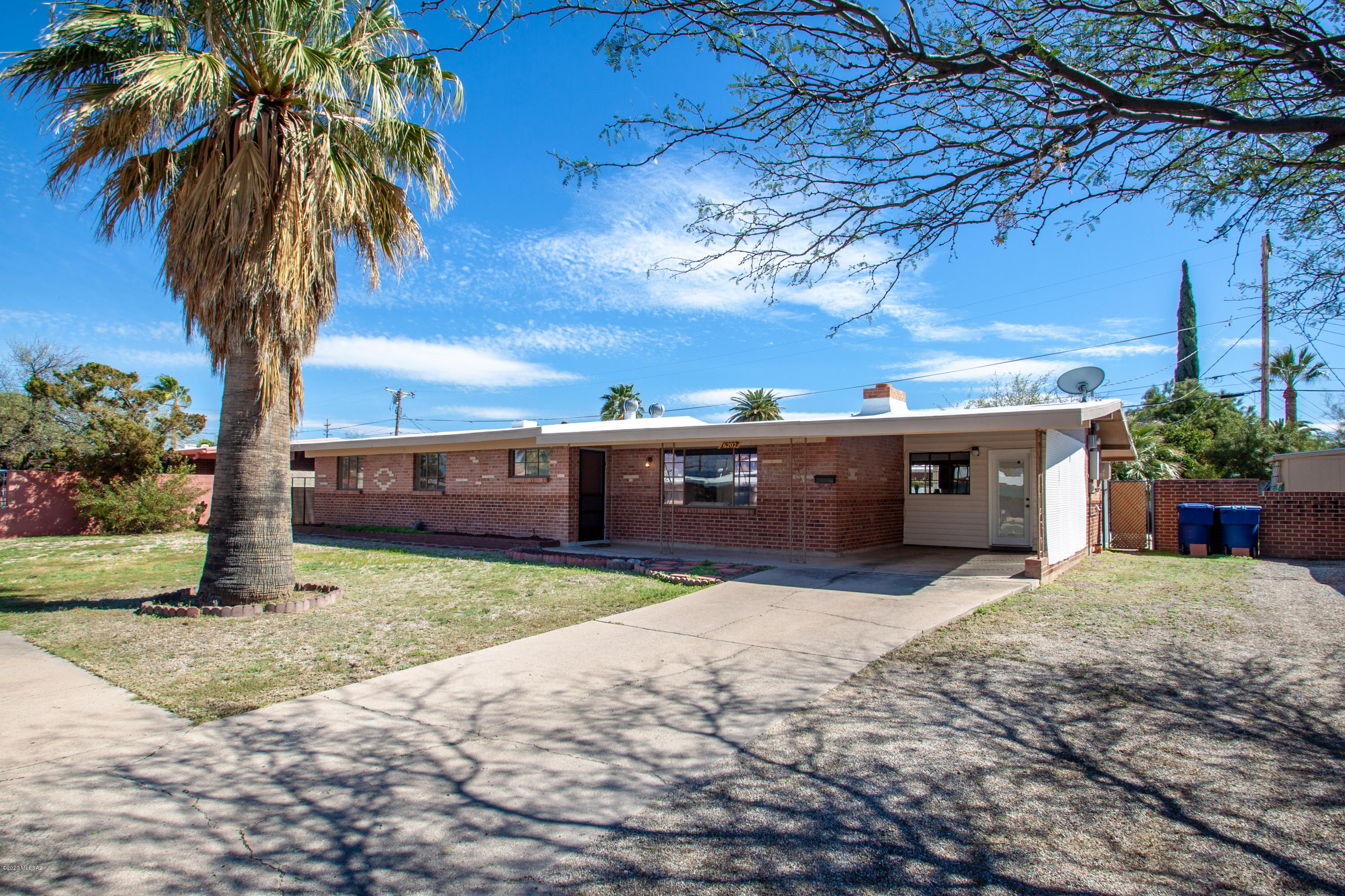 You will love this Mid-Century classic red brick ranch home in excellent mid-town location!   This well maintained home has so many classic features of the era: built in linen closet, china cabinet and the classic casement windows + stone fireplace... truly charming and inviting.  Extra large kitchen, certainly ahead of it's time, has a wall oven, dishwasher, built in cutting board (you don't see that everyday) and peninsula with seating.  Clean and crisp with fresh interior paint, super clean down to the detail.  All tile floors, no carpet here! Hard to find 4 bedrooms with a swimming pool!  Perfect N/S orientation gives a nice bit of mountain view from the living room picture window.  Great entertaining backyard with covered patio, grassy area and huge 12x20' storage shed.  Must see!