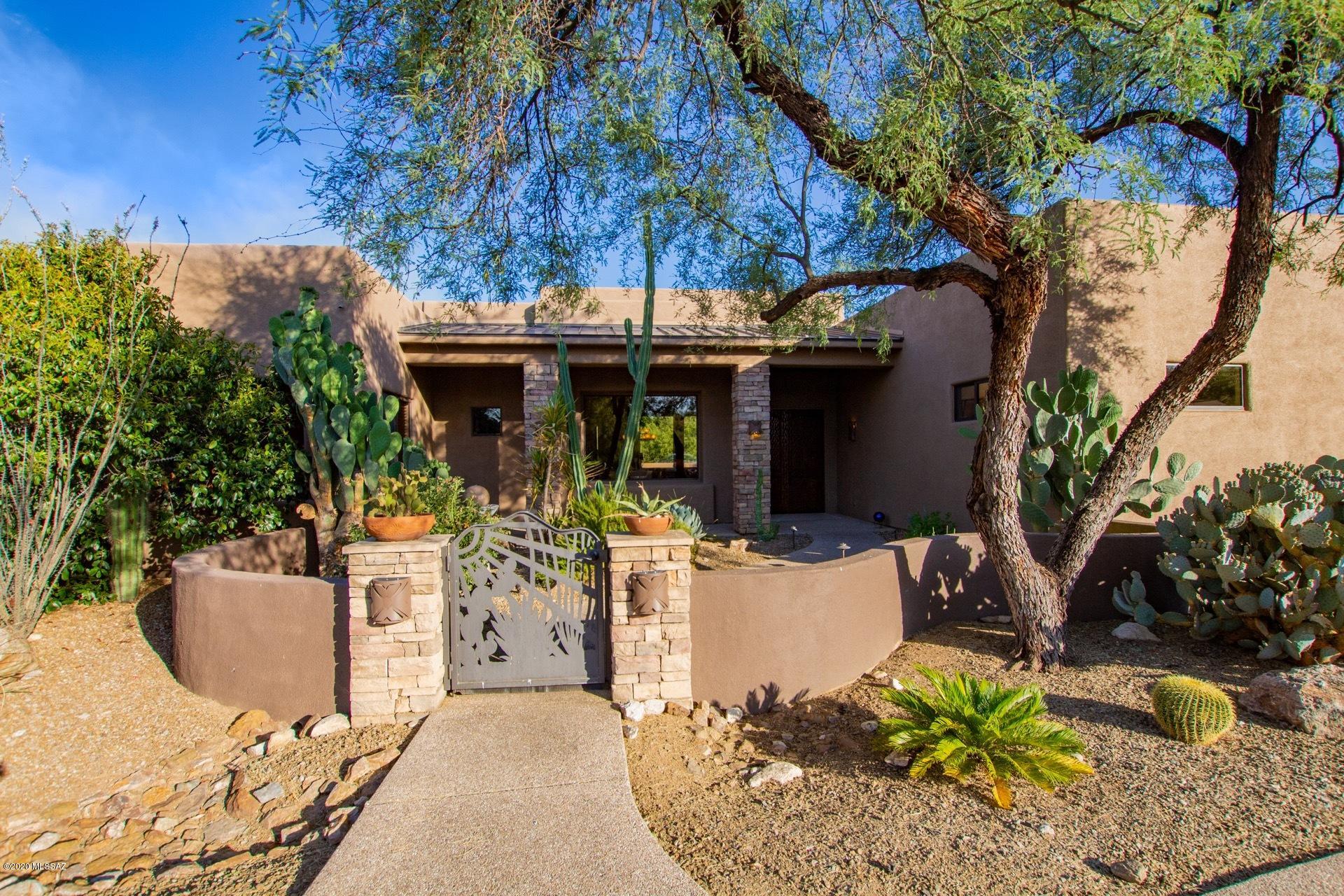 Nestled at the base of the Catalina Mtns in a small gated community, this home borders Catalina State Park & is situated on 3.3 acres. Through a charming courtyard w/ fountain you will enter this four bedroom, four & a half bath home where each bdrm has a full bath ensuite. Additionally, there is a separate guest casita w/ kitchenette & full bath. The outdoor living provides a salt-water pool, spa w/ spill over waterfall, outdoor kitchen w/ built-in BBQ & an impressive outdoor fireplace w/ extensive flagstone patios perfect for entertaining. The highly upgraded gourmet kitchen has everything a chef could need. Double ovens, five burner gas cook-top, two dishwashers, warming drawer, wine refrigerator, pasta faucet, prep-sink & trash compactor. Owner/agent. You will find only natural stone throughout the home. The floors are chocolate Travertine imported from Turkey & each bathroom features a different natural stone. The great room, family room & owner's suite each have a stone gas fireplace. With unobstructed mountain views this home is one of a kind. Original owner.
Tucked away in a very private setting yet close to major shopping and hospital/medical.
Please see the features list for all of the unique wonderful highlights of this home.