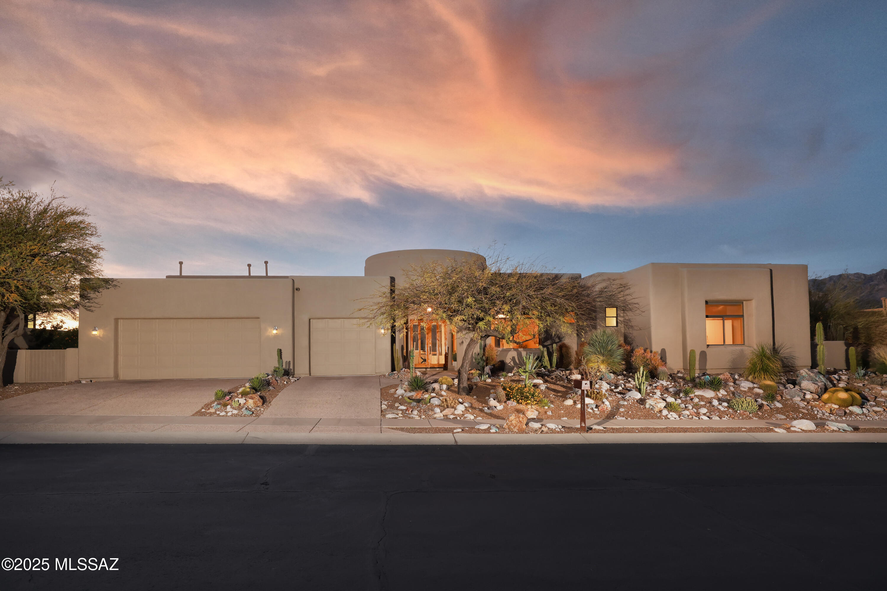 Perched atop the exclusive double-gated Sabino Mountain Community, this 4,641 sqft luxury estate offers an unparalleled desert living experience with breathtaking, unobstructed mountain views. Designed for both comfort and sophistication, this 4-bedroom, 4.5-bathroom masterpiece features oversized windows, a bright, open-concept layout, and soaring ceilings, filling the home with natural light. The expansive chef's kitchen is a culinary dream, boasting granite countertops, high-end appliances, and an oversized island—ideal for entertaining. 
The huge primary suite is a serene retreat, complete with a spa-like bathroom featuring a jet tub, double shower, and elegant finishes. Architectural details such as graceful arches, curves, and custom niches add to the home's modern elegance.