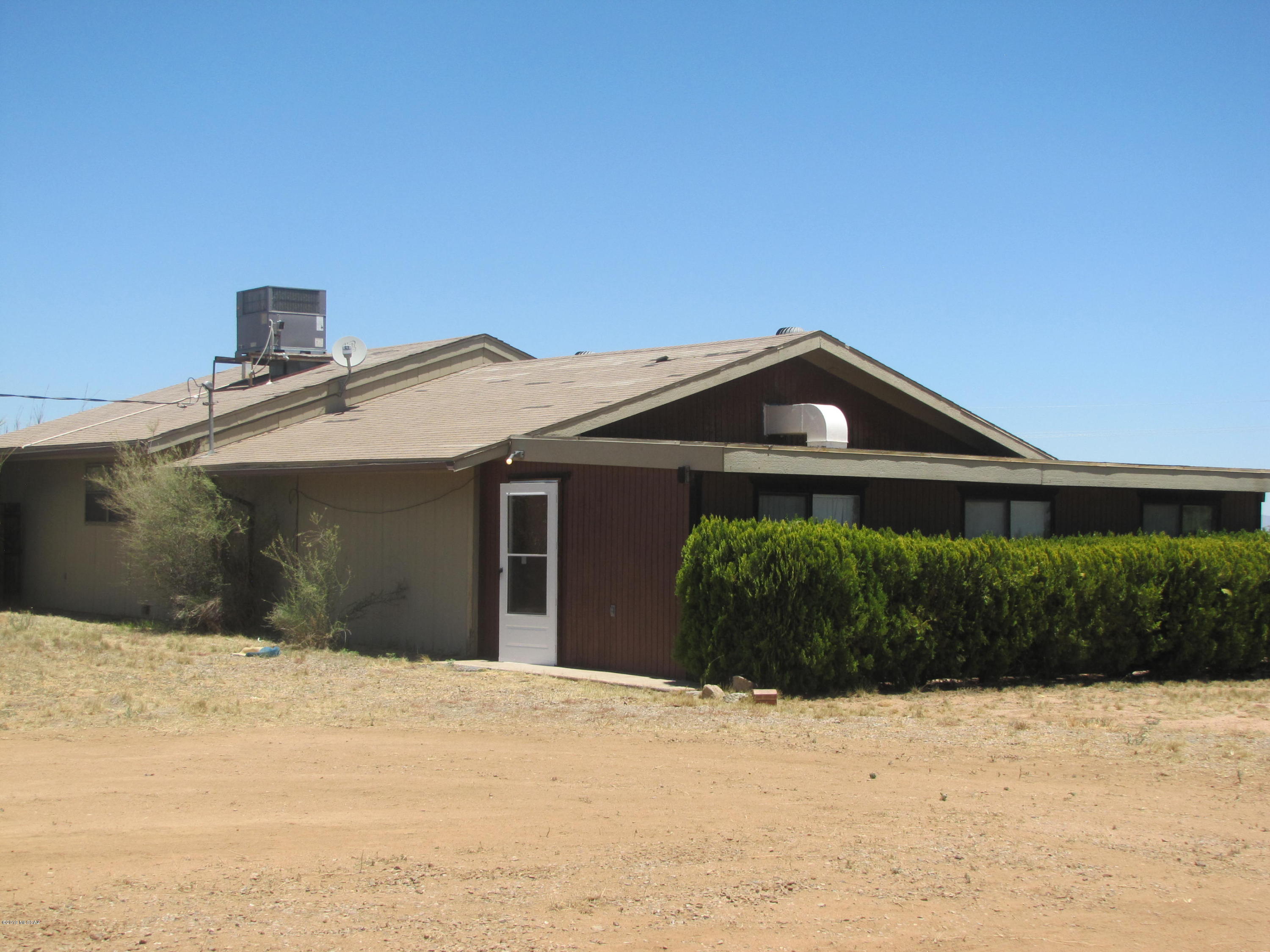 Corner parcel + additional acreage with so much to offer! Main house is 2BR/2Ba with 2 additional rooms that could be game room/office/BR. Kitchen/dining area lead into mudroom with garden sink. LR has access to 1 of 3 AZ rooms, 2 of which go into fenced backyard. Guest house is 2BR/1Ba with open floor plan & carport. Arena, round pen, tack room/horse barn w/corrals, hay/equipment storage barn, covered RV parking & additional outbuildings. Total of 9.67ac mostly fenced & cross fenced. North boundary is paved with quick access to Hwy 191 & I-10.. Sale includes APNs 206-23-001 & -032; taxes shown for both parcels.