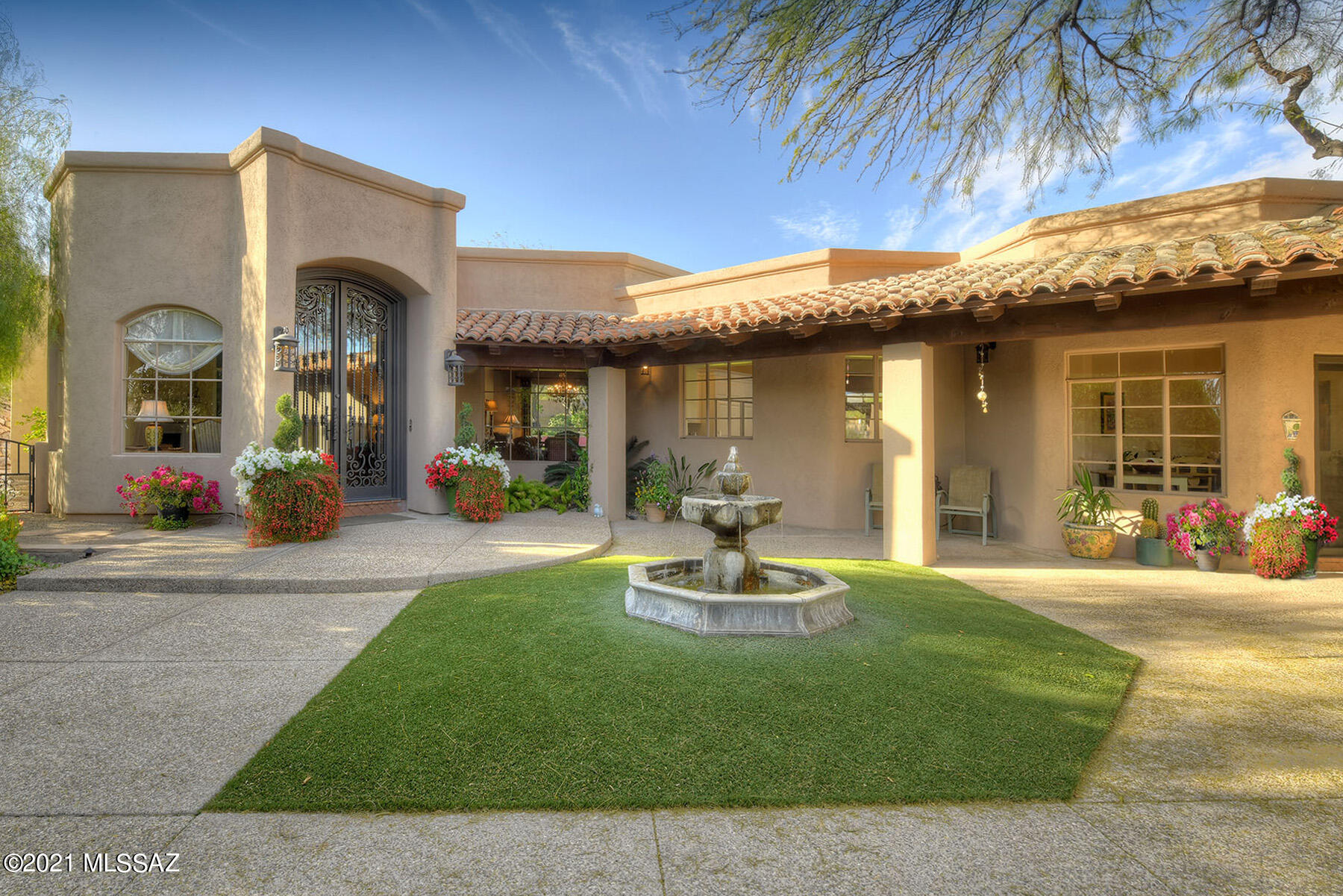 Exquisite traditional Arizona home w/majestic mountain views on secluded 1.5 acres in prestigious gated Catalina Foothills Estates #10. Dramatic front  gated courtyard w/fountain & grass, 4747 sq. ft., foyer entrance w/fireplace, living rm w/high ceilings, walls of windows, elegant fireplace, formal dining rm, gourmet island kit w/ classic white cabinets, granite countertops, dbl ovens, gas stove top, Sub Zero, breakfast rm, cozy family rm w/fireplace,  gorgeous real wood floors & french doors, 5 BR's + study w/built in bookcases, 5 BA's, rec/room or playroom, mstr suite w/fireplace, mstr bath w/travertine countertops & flrs, lg walk in closet.  Fabulous bkyd w/cov'd patio, pool, spa, grass, mature fruit trees, BBQ, 3 car gar, circular drive, Dist.16 schools & views, truly perfect!