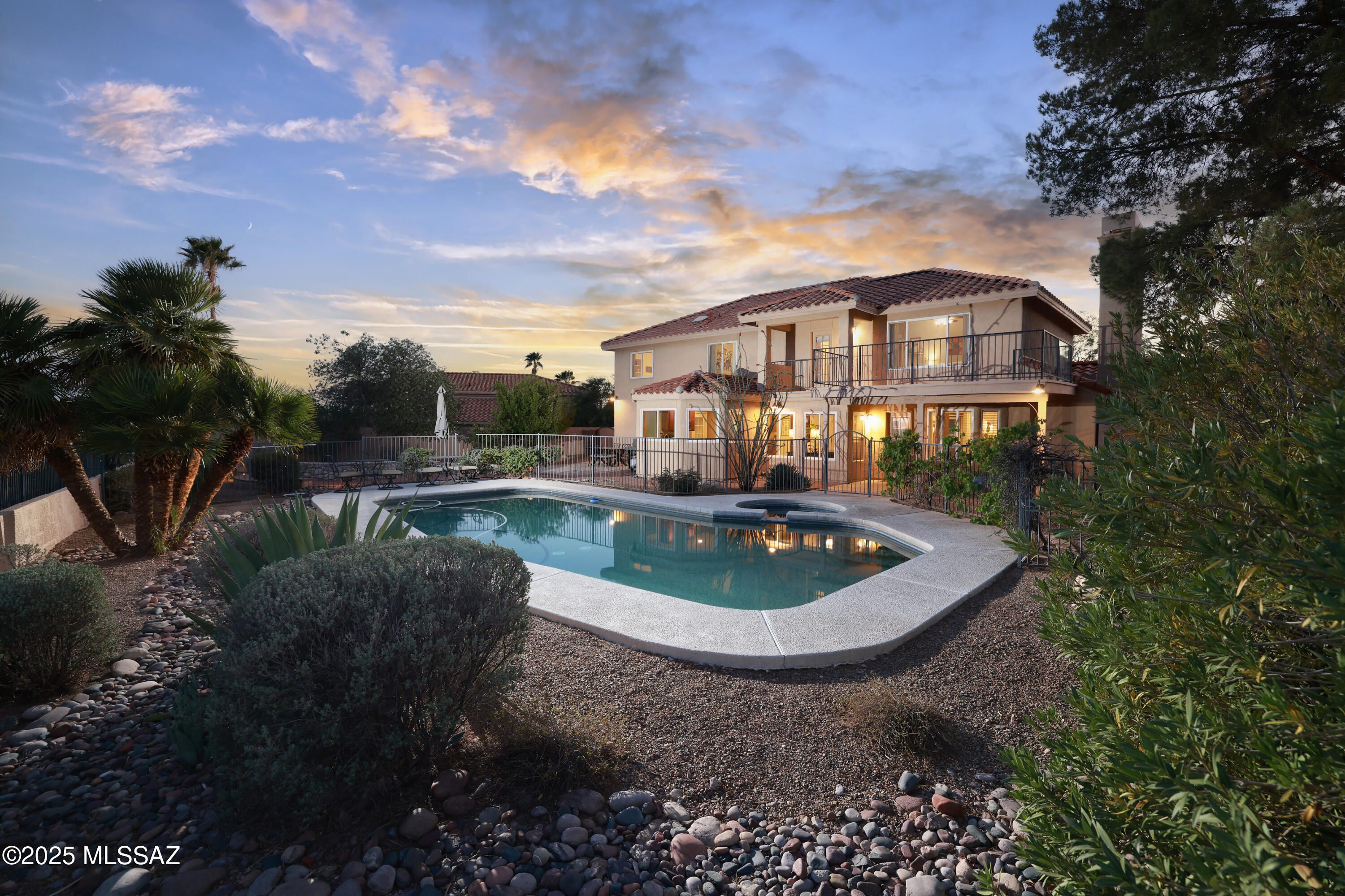 Beautifully updated 5Br/3.5Ba + den home on a quiet cul-de-sac backing to acres of natural desert with breathtaking views of the city lights, the Catalina, Rincon, & Santa Rita Mountains. Huge gourmet kitchen features tons of storage in the maple cabinets, expanse of quartz counters, SS appliances, & wine fridge. Spacious family room w/ stacked stone fireplace & bay window overlooking the yard. Large upstairs primary suite w/ view deck. Oasis backyard features pool, spa, gas fire-pit, lush landscaping, brick walkways & deck space & raised planting bed. Newer HVAC & pool equipment (2013), New 400amp service and panel (2021),  new roof (2025),  upgraded fixtures and flooring throughout.  3rd bay of the garage has mini-split HVAC (not included in Sqft) and is perfect workshop/exercise space.
