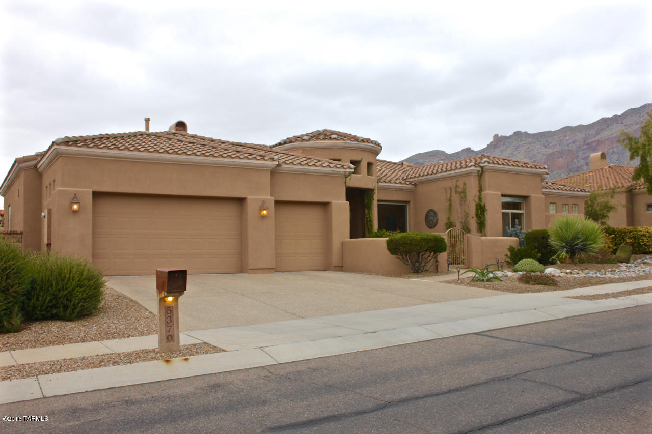 Beautiful AF Sterling home boasts of many great features. Gated front entry/courtyard. Large open floor plan w/ high ceilings & many niches. Large master bedrm suite w/ huge his & hers walk in closets & vanity/sinks, garden tub & glass block walk in shower. Jack & Jill bathrm w/ separate vanity/sink area. One of the bedrms is all set for your U of A Fan. Ceiling fans in all bedrms & family rm. Breakfast bar & nook for table. Large kitchen w/ granite countertops & stainless steel appliances. Cabinets & Sink in laundry rm. Swiss & Martin Wood Shutters on almost every window. Spectacular views from windows & the extended rear covered patio. Enjoy playing in the pool w/ water feature & fantastic view of the Catalina Mtns. Variety of citrus trees in backyard. 2013 new HVAC units.